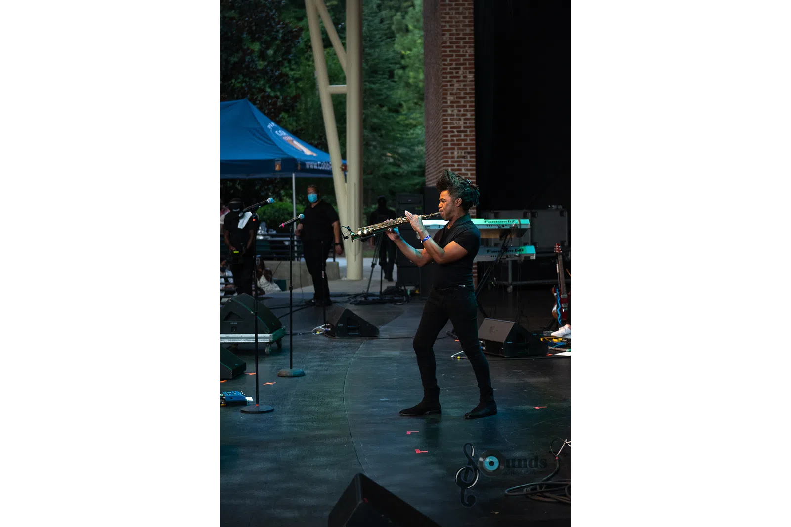 a group of people playing instruments and performing on a stage