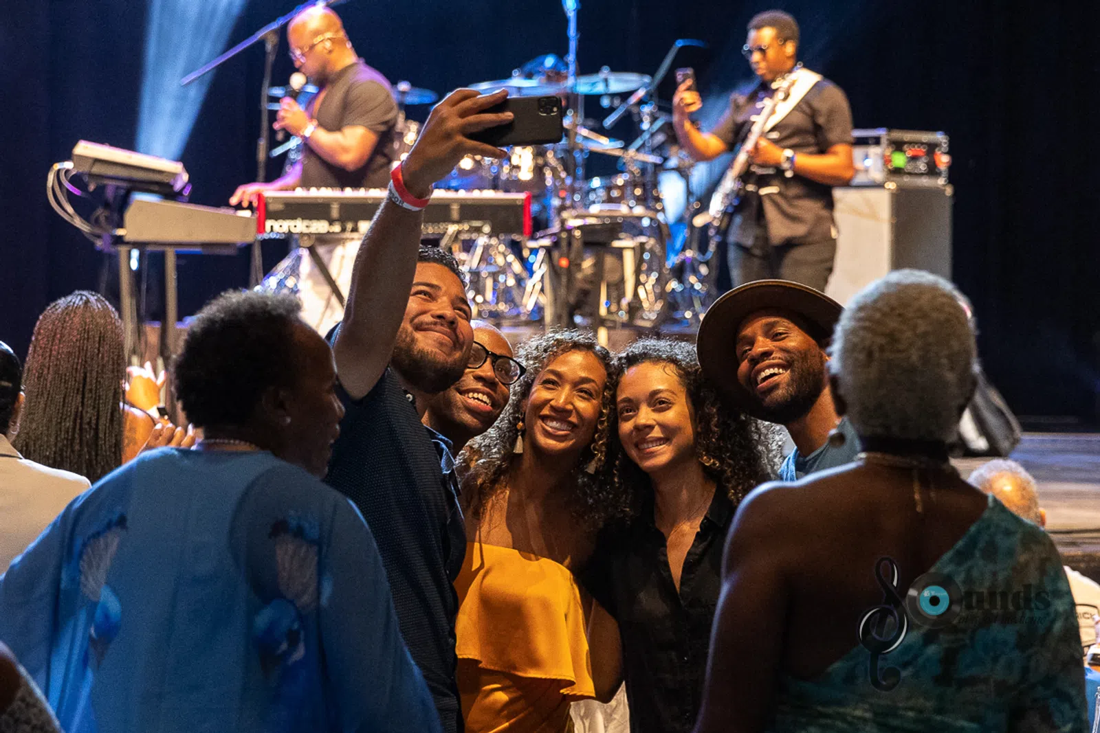 a group of people standing on a stage in front of a crowd