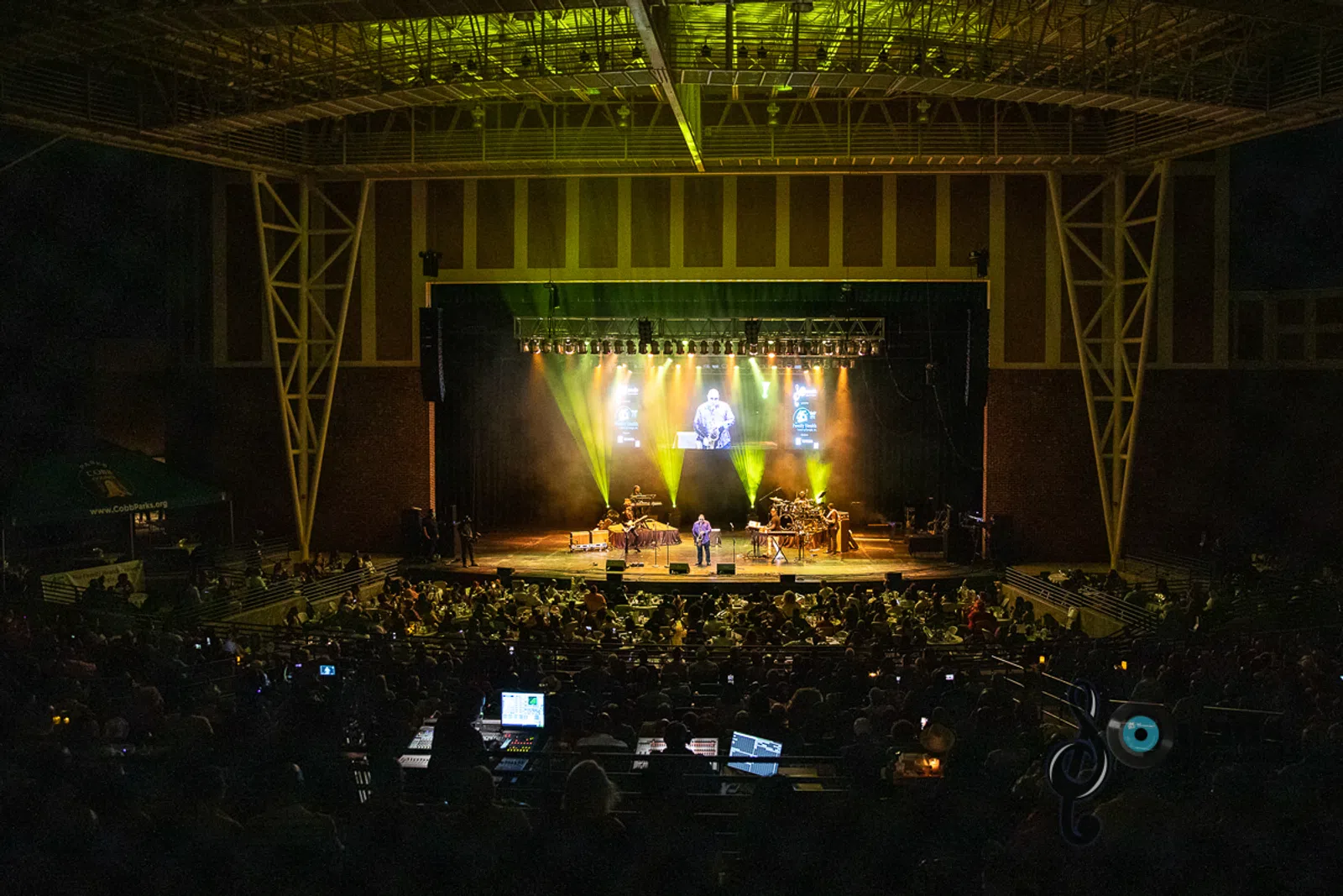 a band performing on stage in front of a fireplace