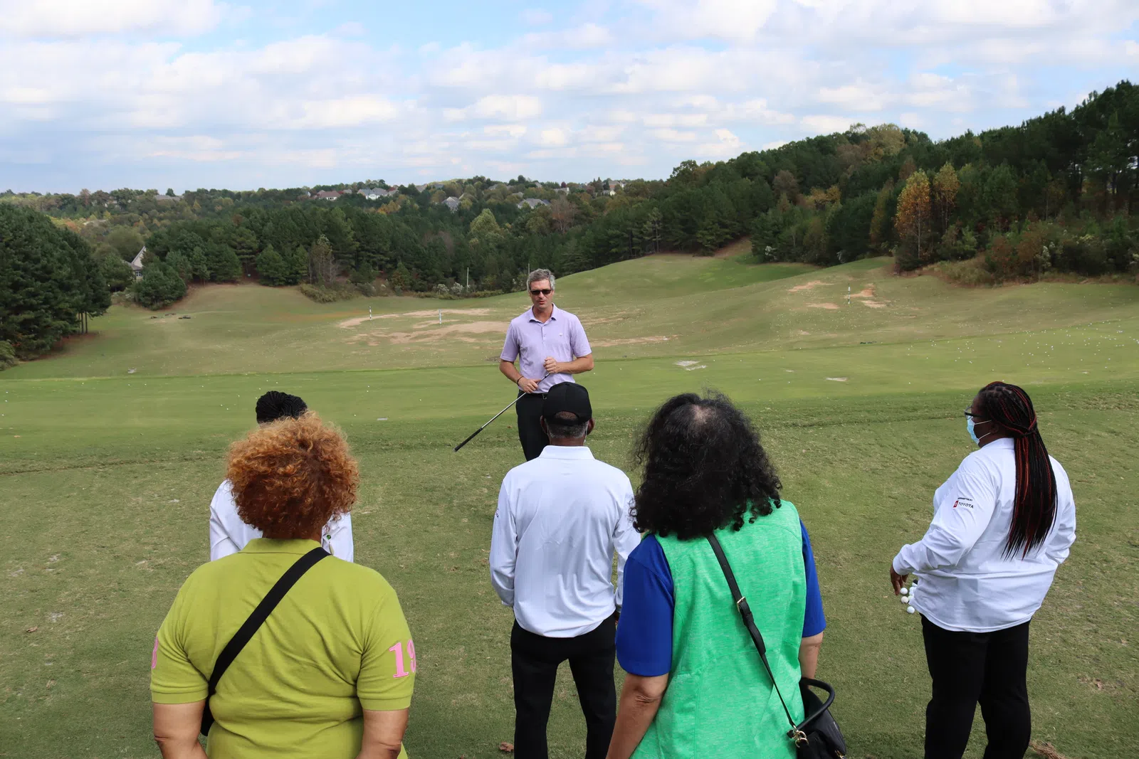 a group of people on a golf course