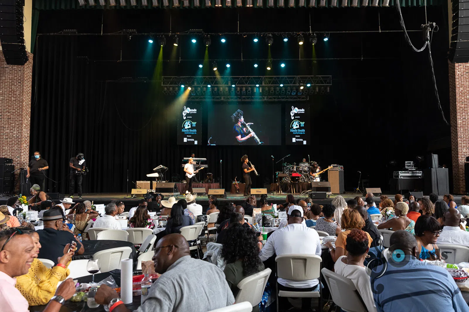 a group of people sitting at a table in front of a crowd
