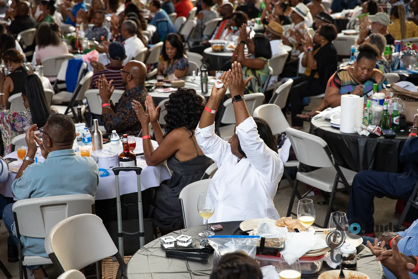 a group of people sitting at a table in front of a crowd