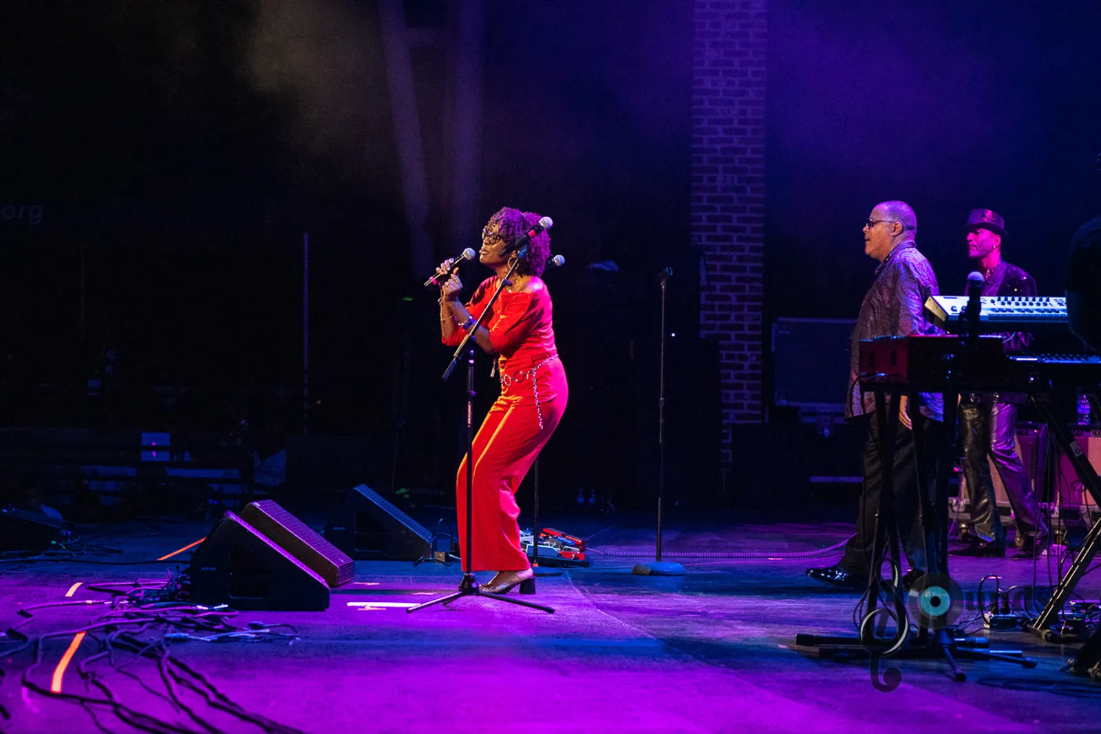 a group of people playing instruments and performing on a stage