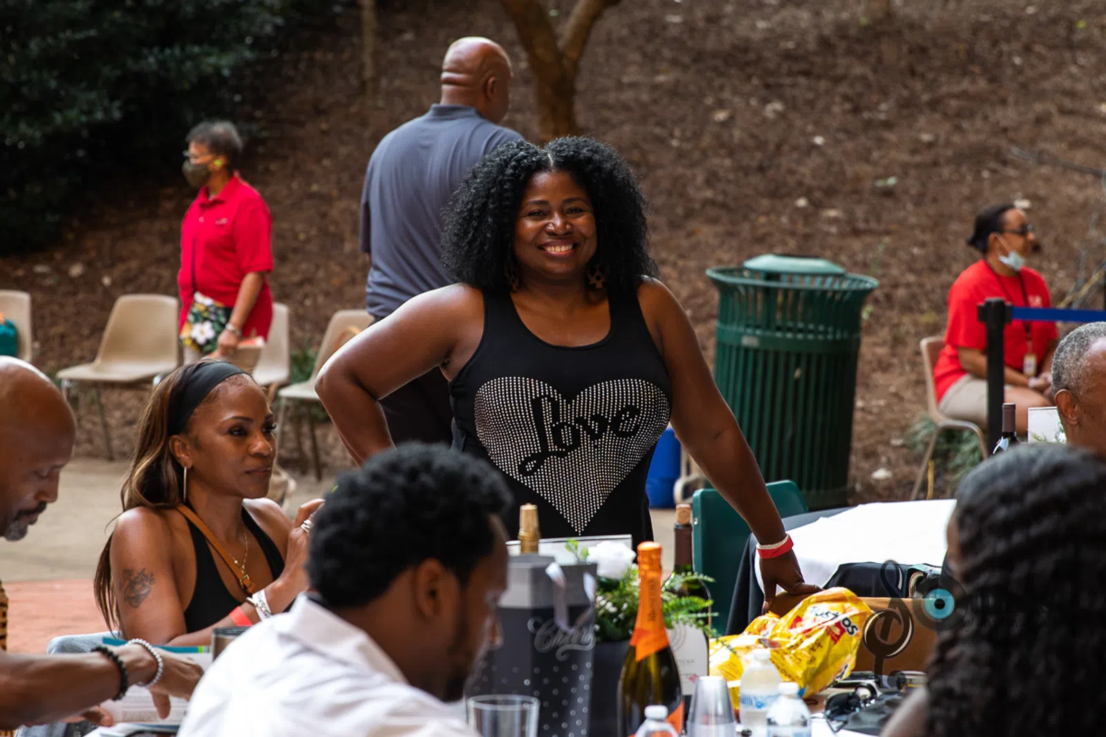 a group of people standing around a table