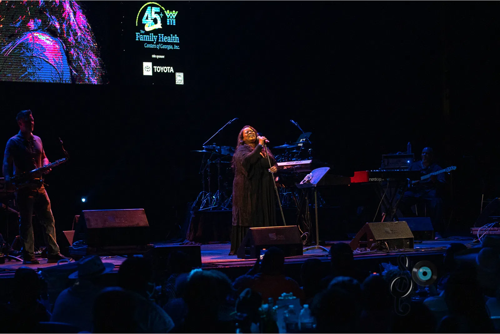a group of people on a stage in front of a crowd