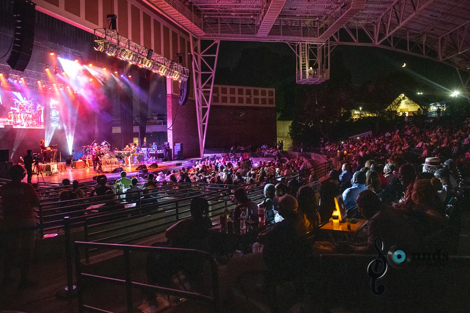 a group of people on a stage in front of a crowd