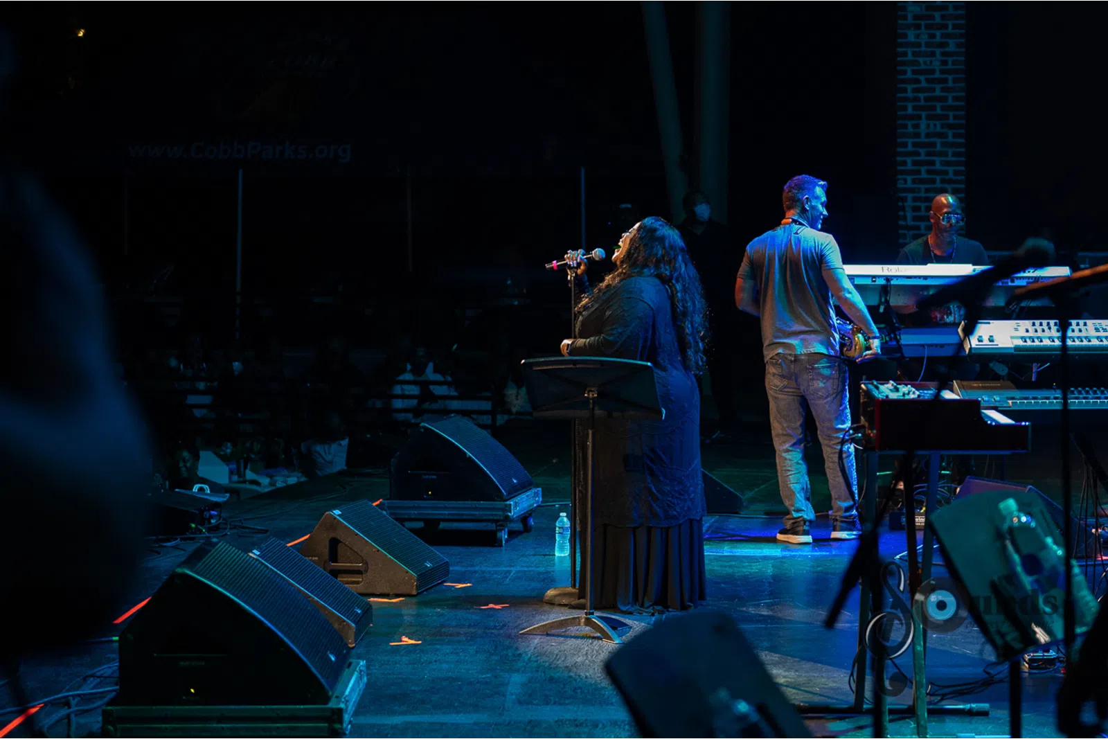 a group of people playing instruments and performing on a stage
