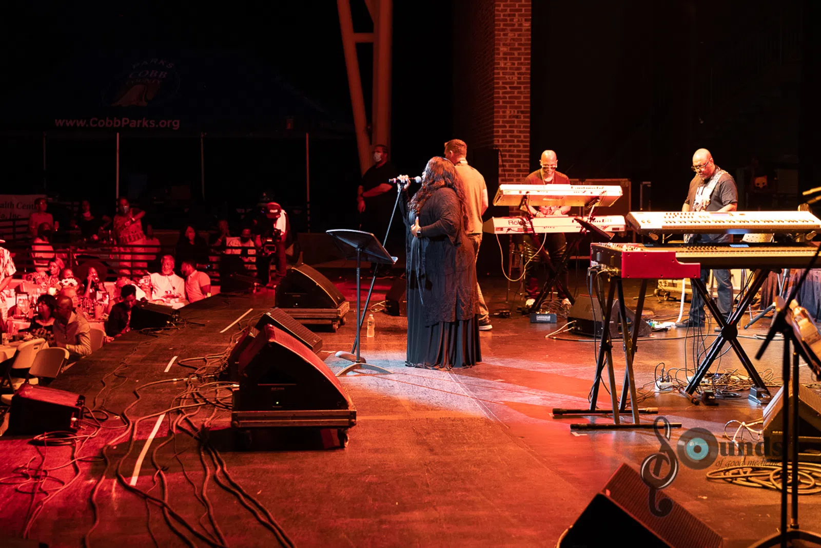 a group of people playing instruments and performing on a stage