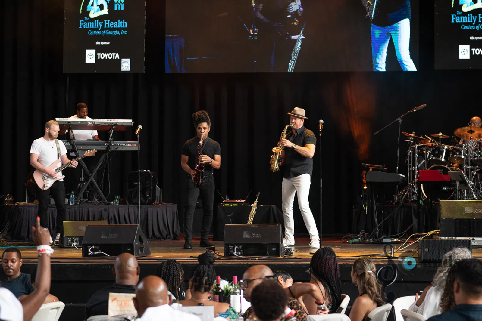 a group of people sitting on a stage