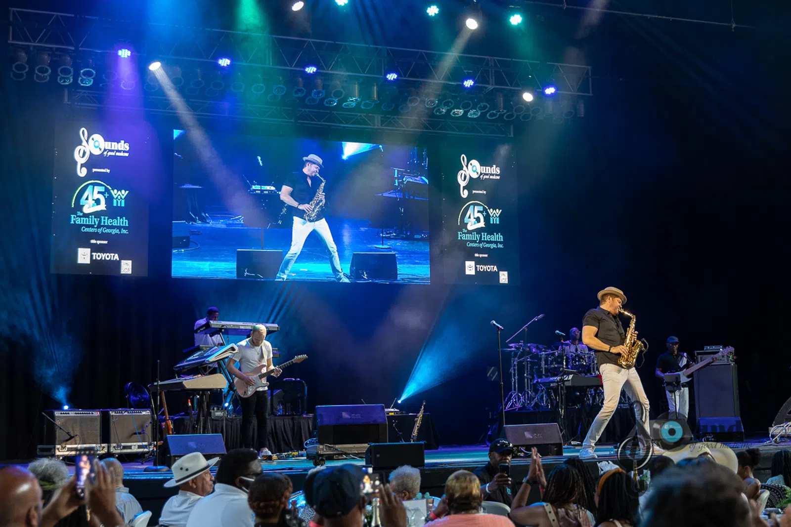 a group of people on a stage in front of a crowd