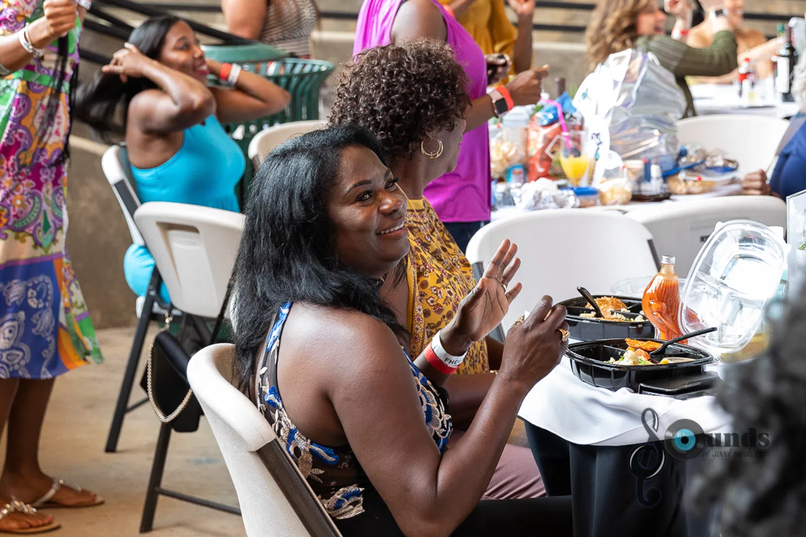a group of people sitting at a table in front of a crowd
