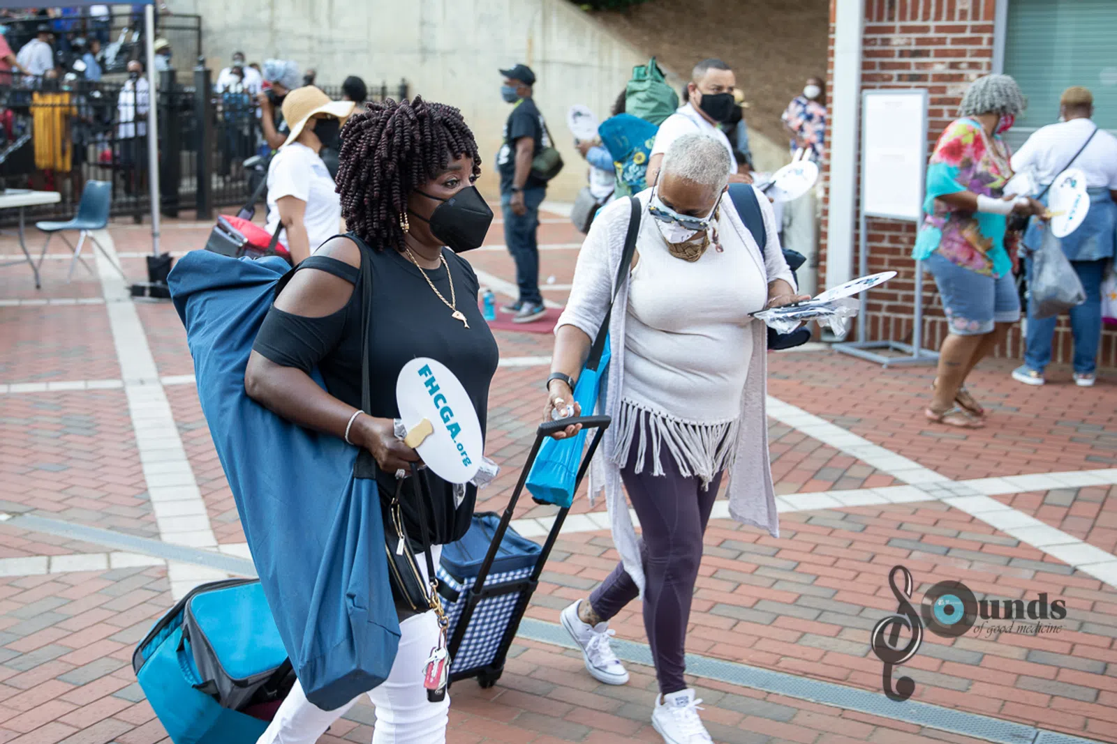 a group of people walking on a sidewalk