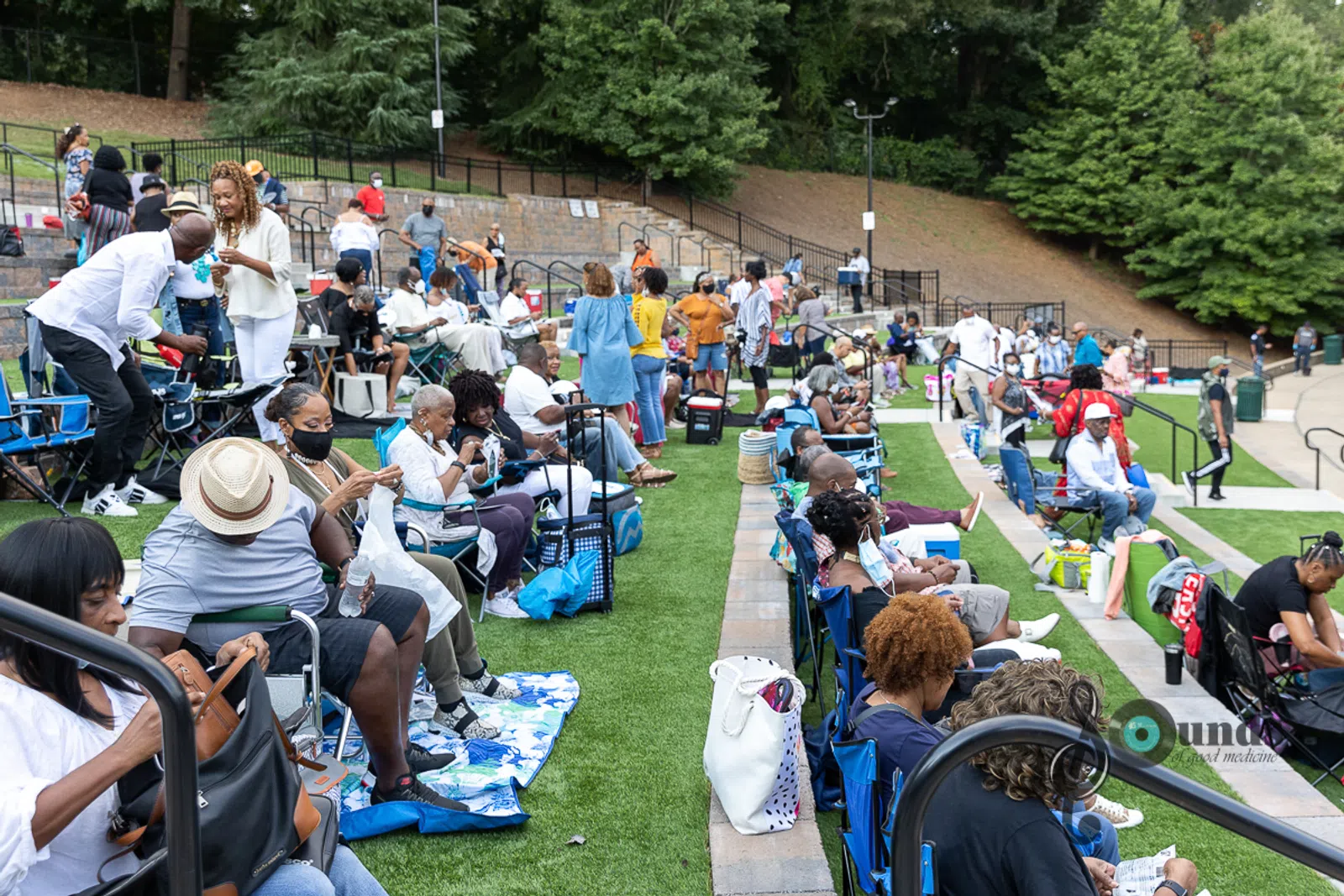 a group of people sitting at a park
