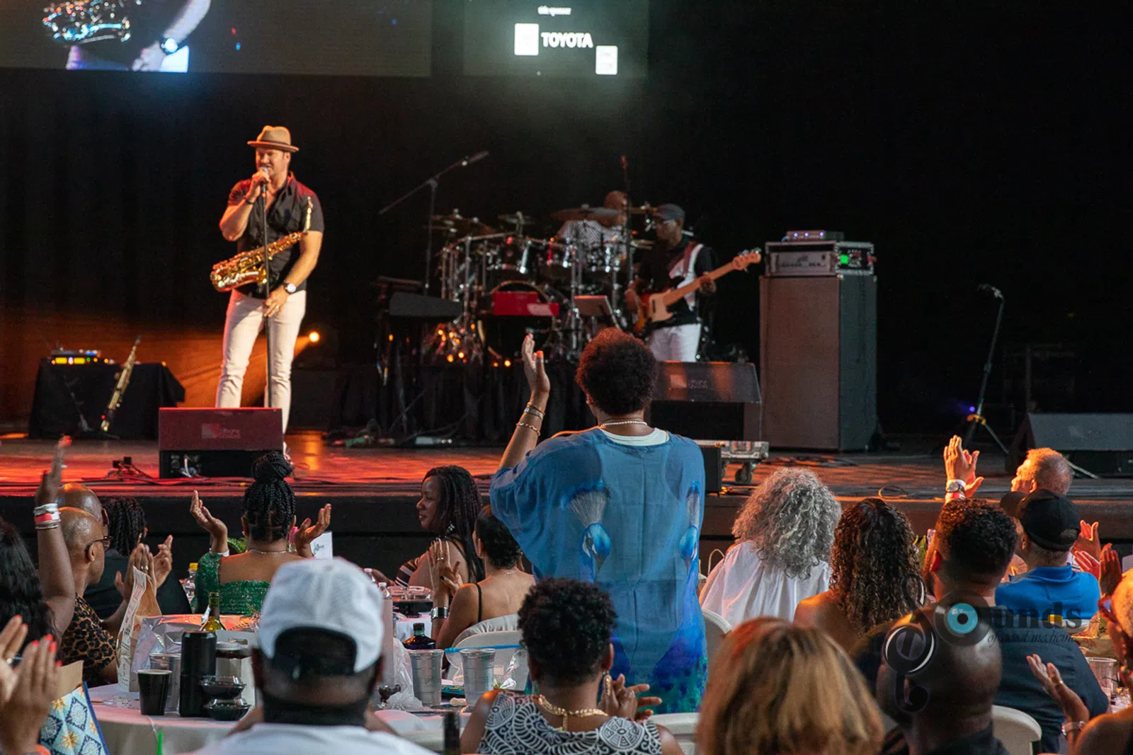 a group of people standing on a stage in front of a crowd