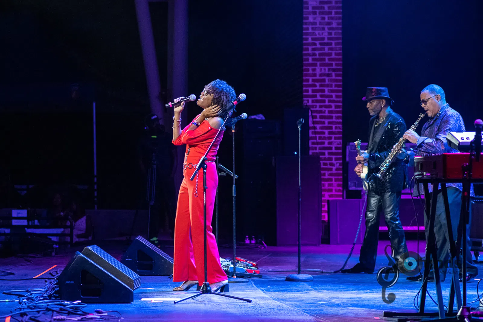 a group of people playing instruments and performing on a stage