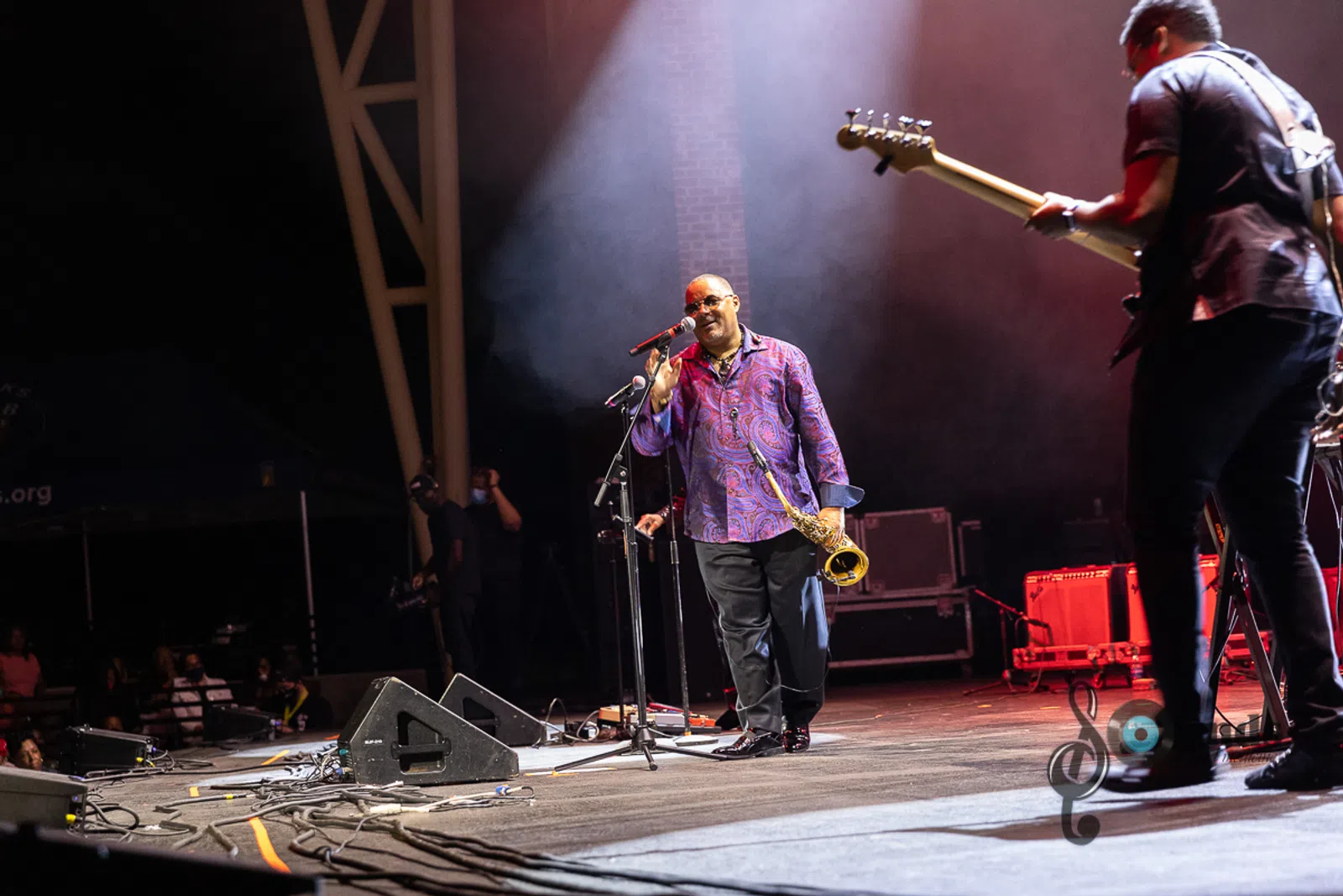 a person standing on a stage playing instruments