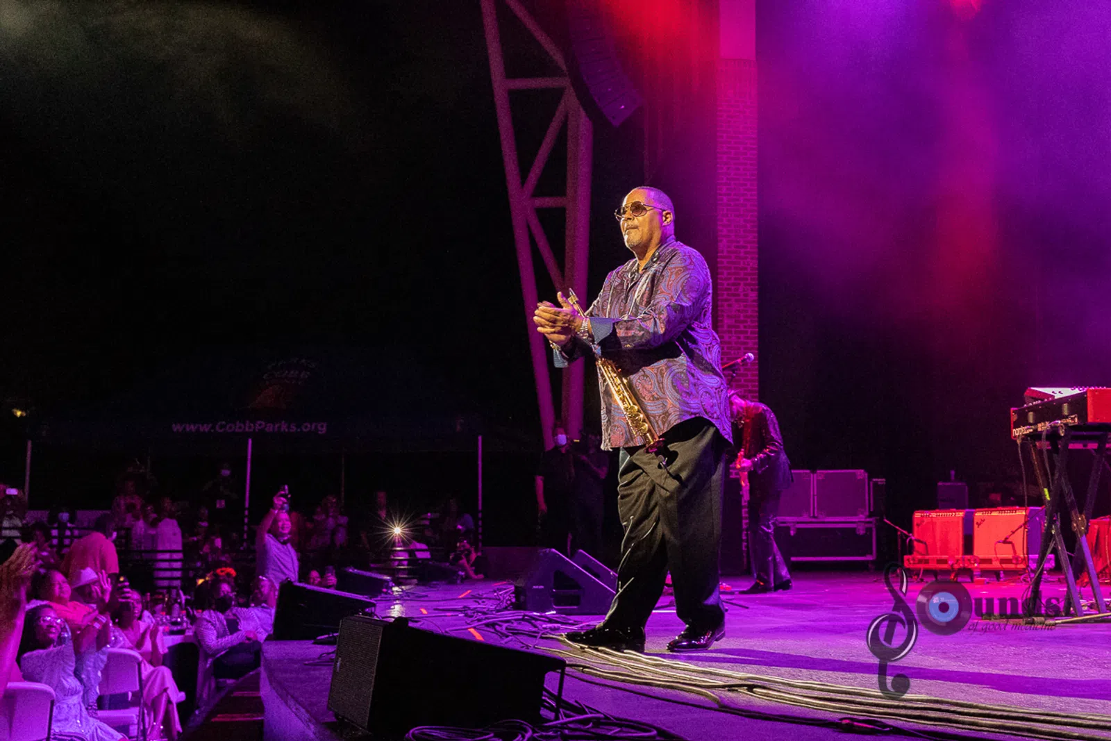 a man standing on a stage playing instruments