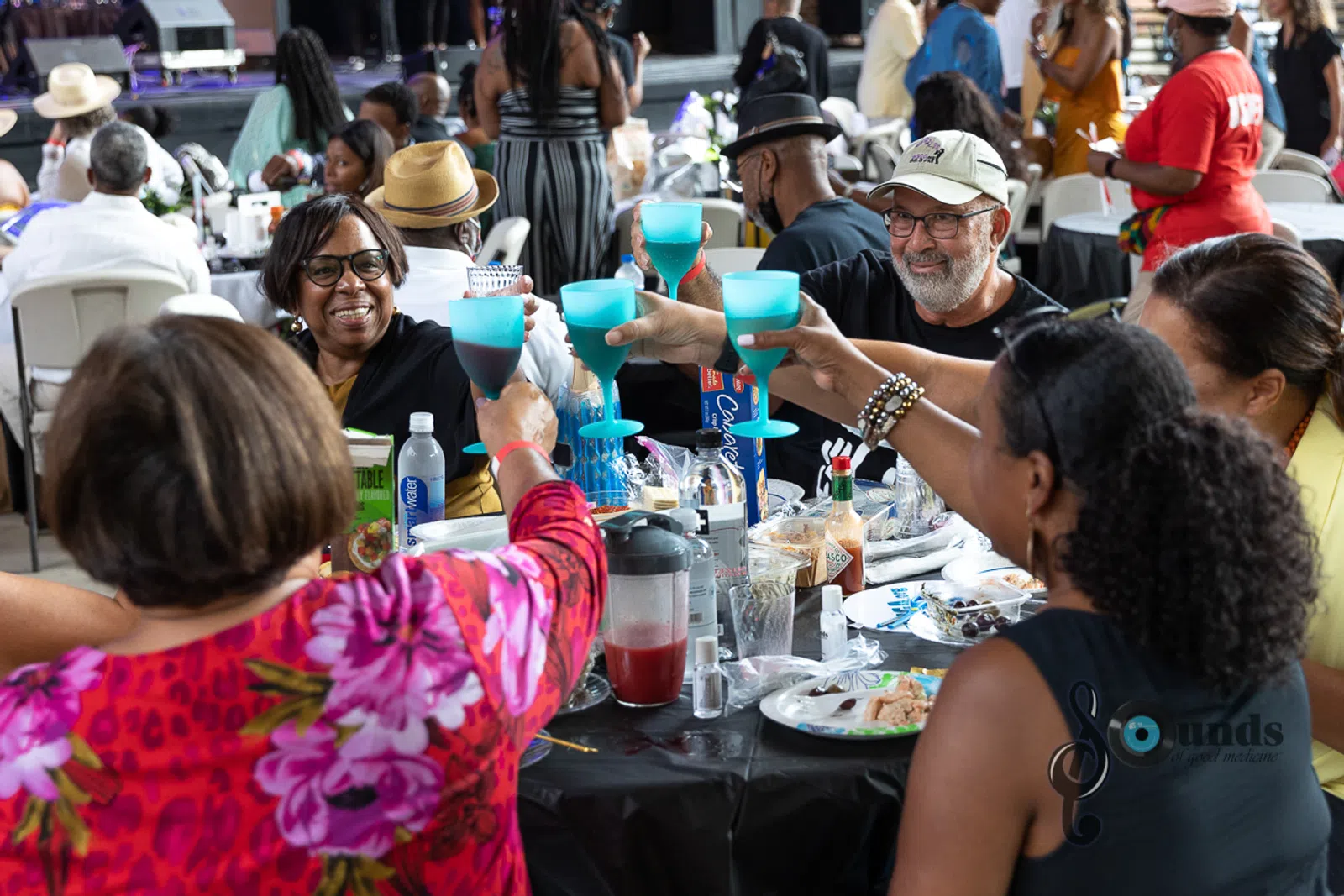 a group of people sitting at a table in front of a crowd