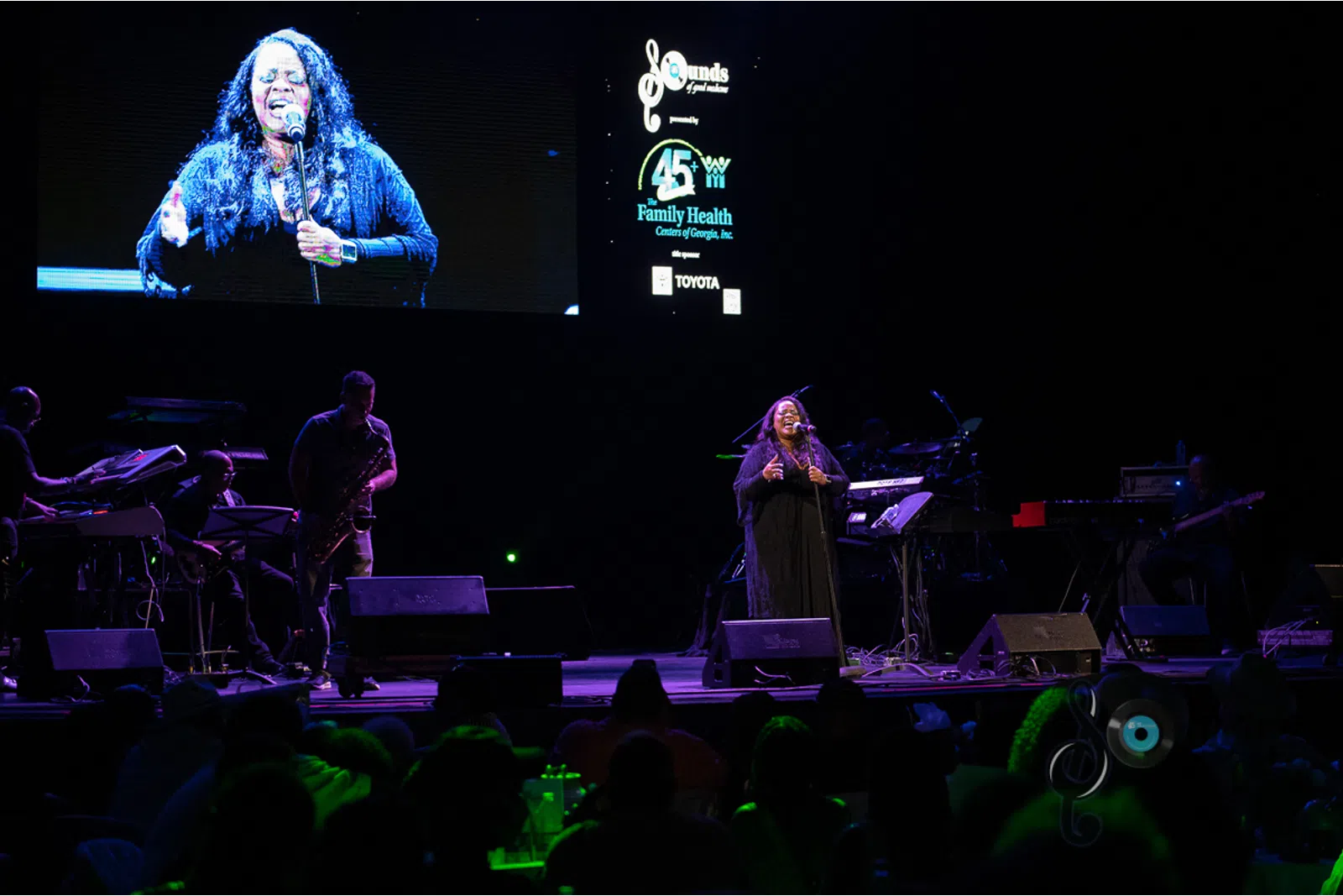 people playing instruments on a stage