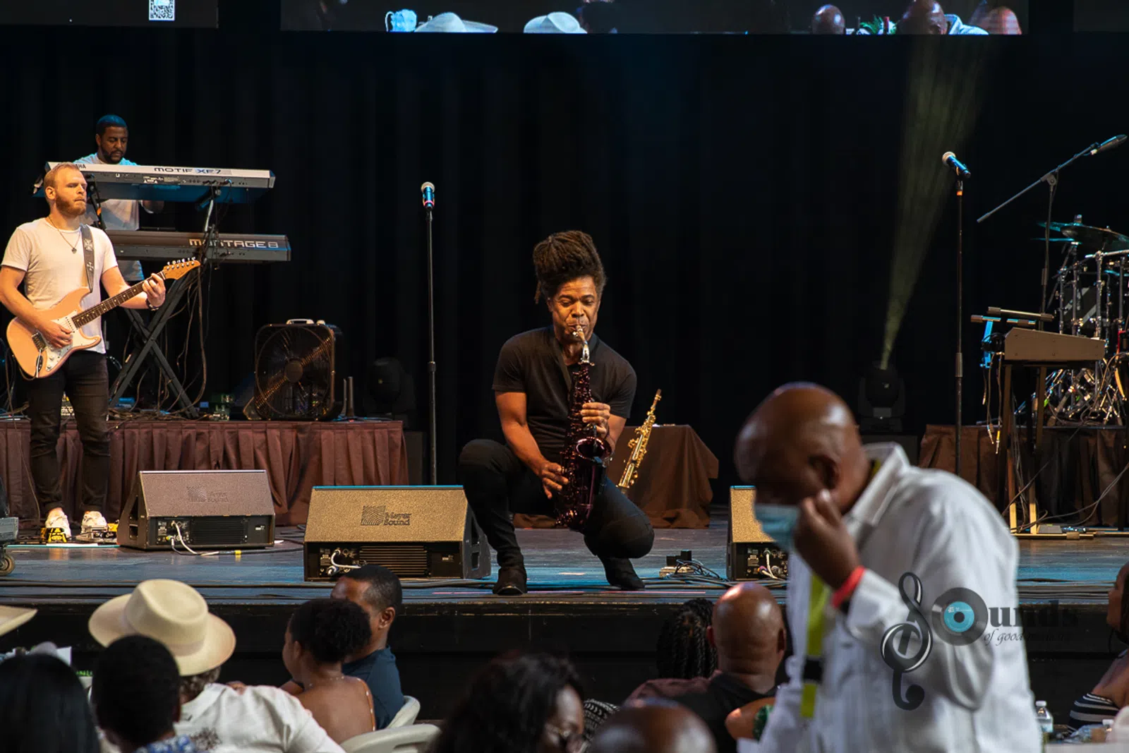 a group of people on a stage in front of a crowd