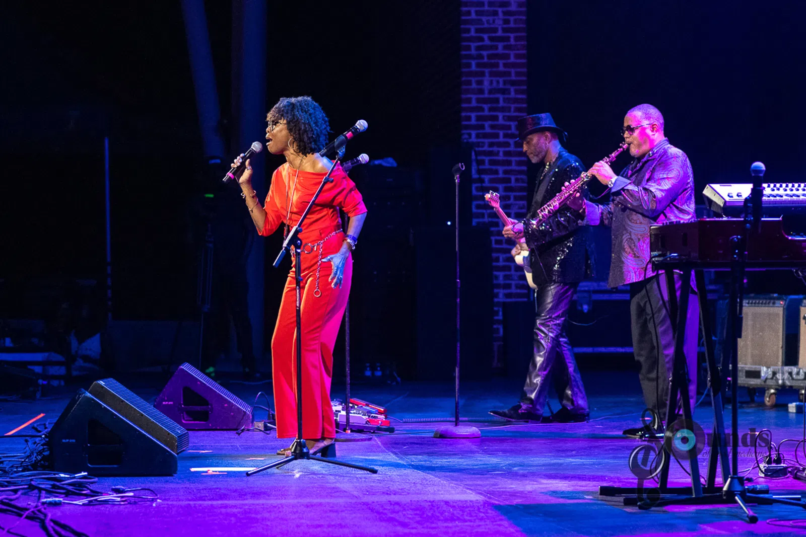a person standing on a stage playing instruments