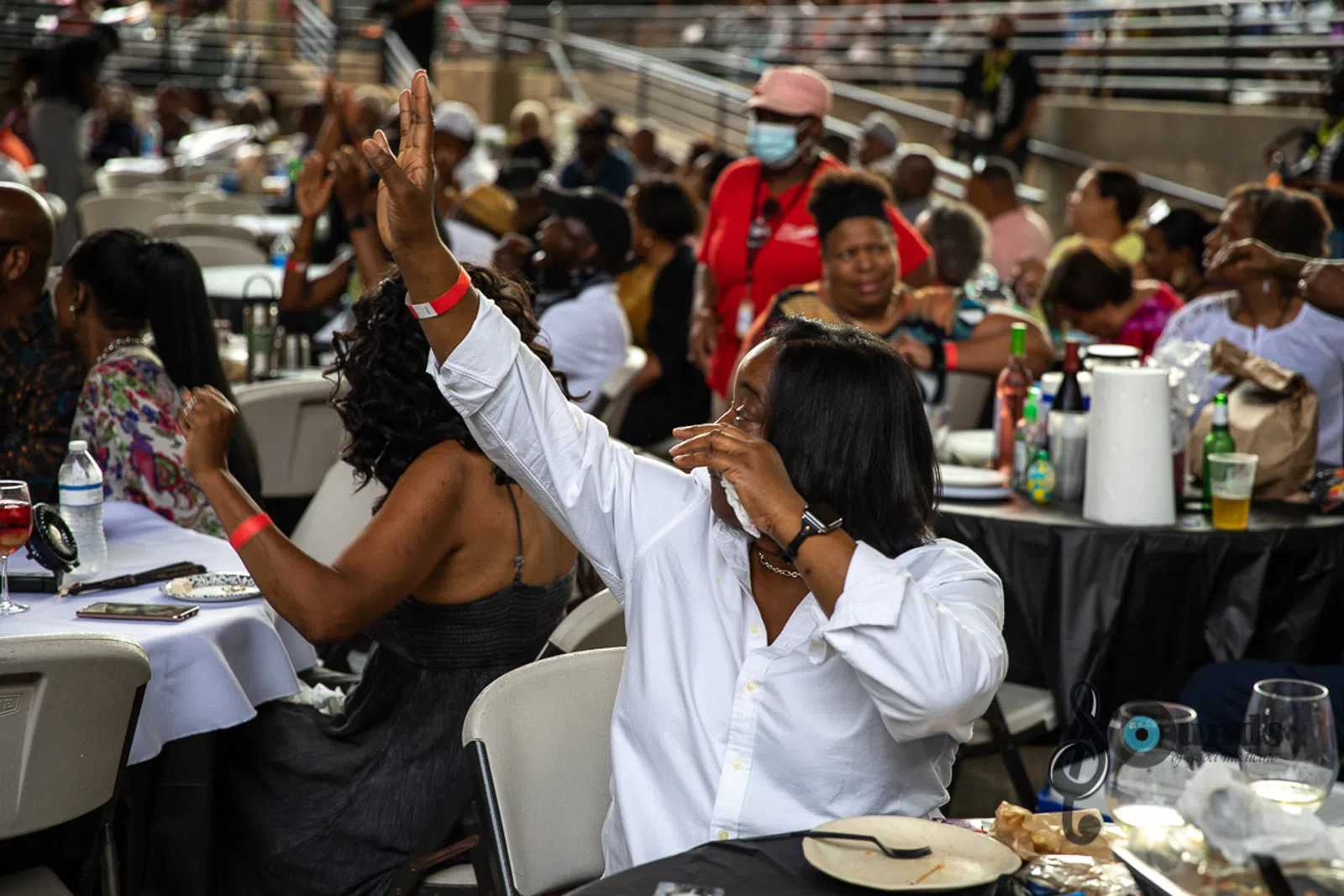 a group of people sitting at a table in front of a crowd
