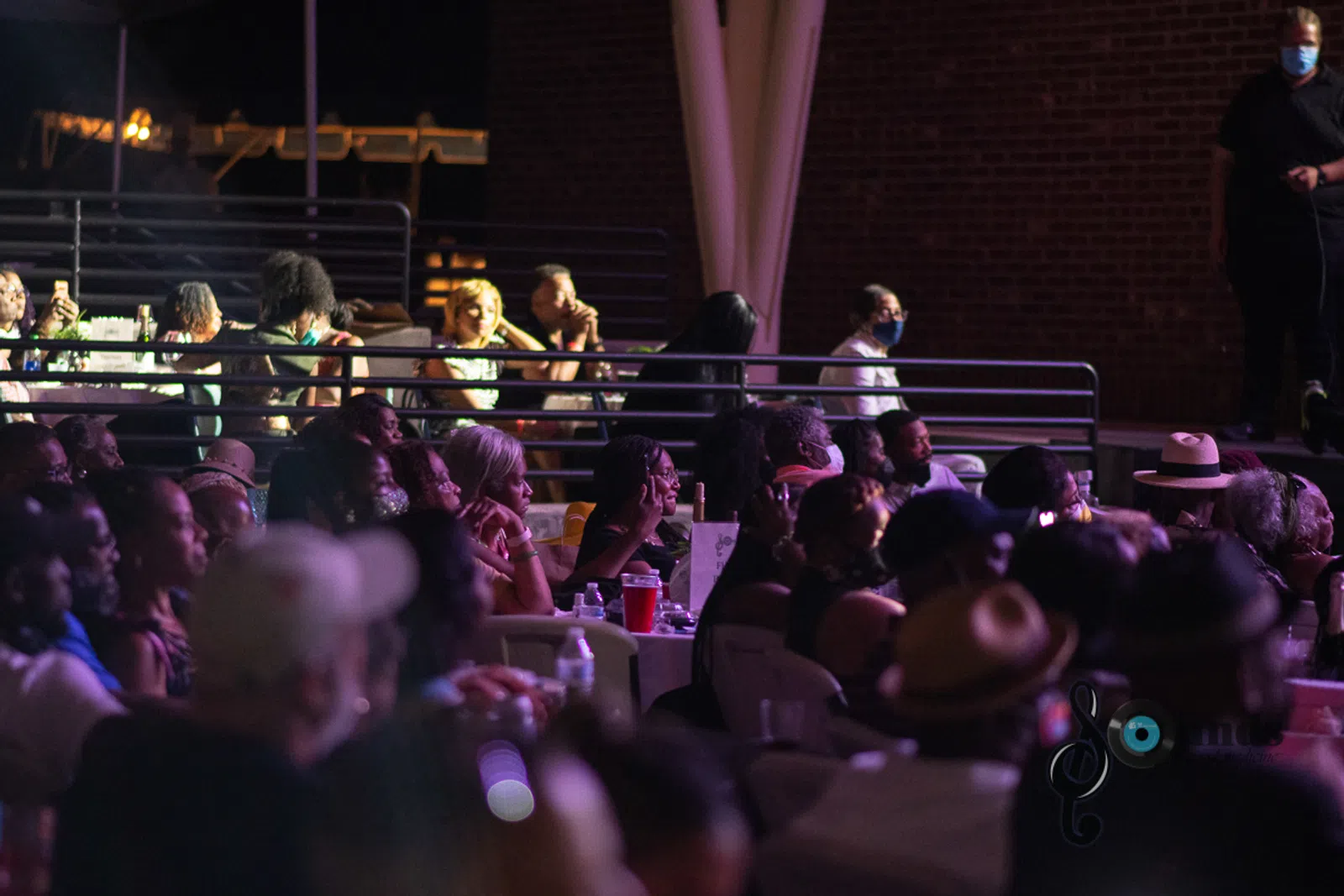 a group of people sitting in front of a crowd