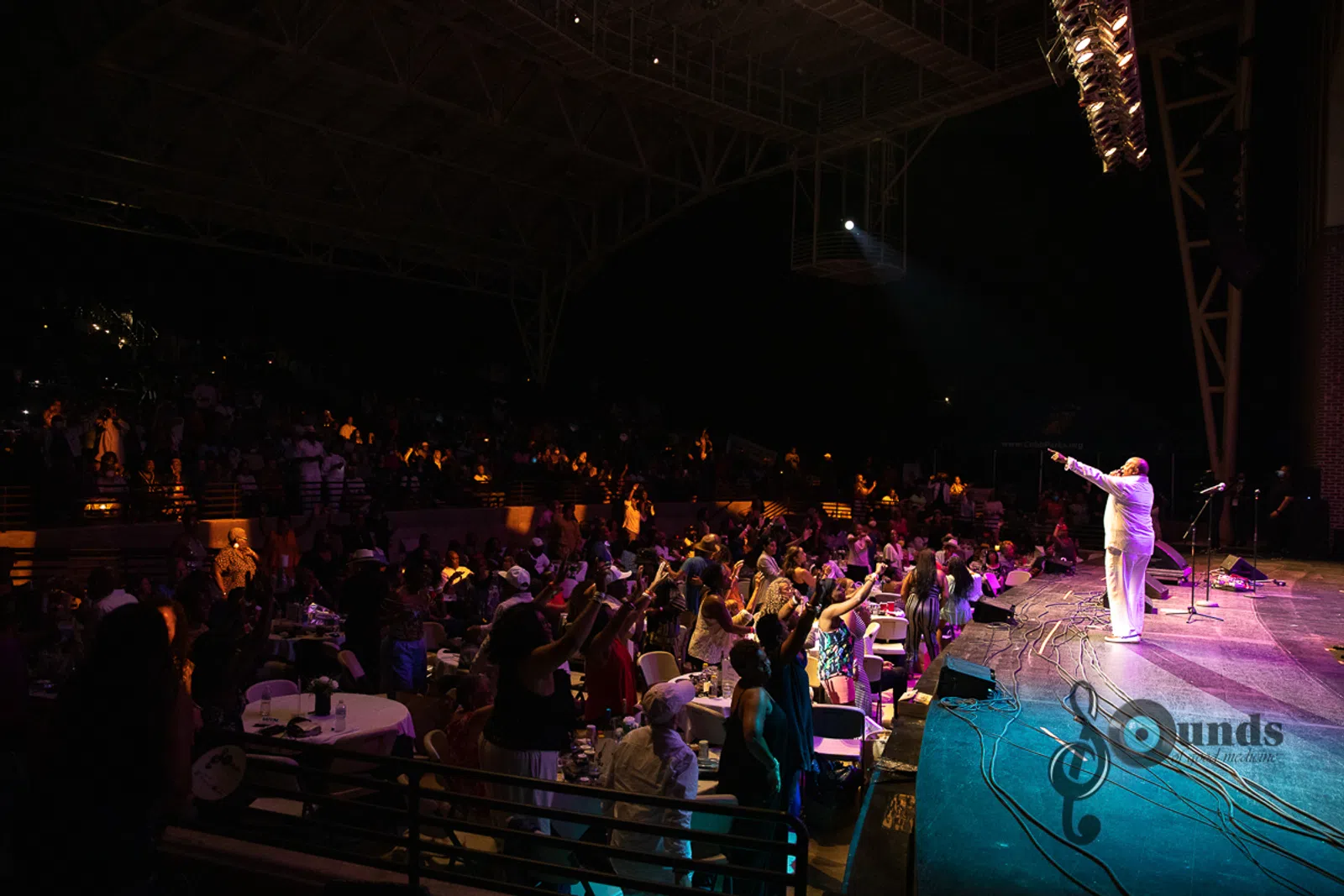a group of people on a stage in front of a crowd