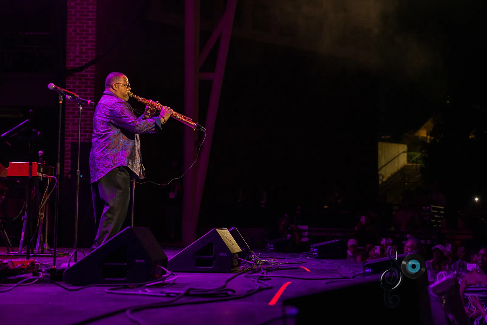 a man standing on a stage playing instruments