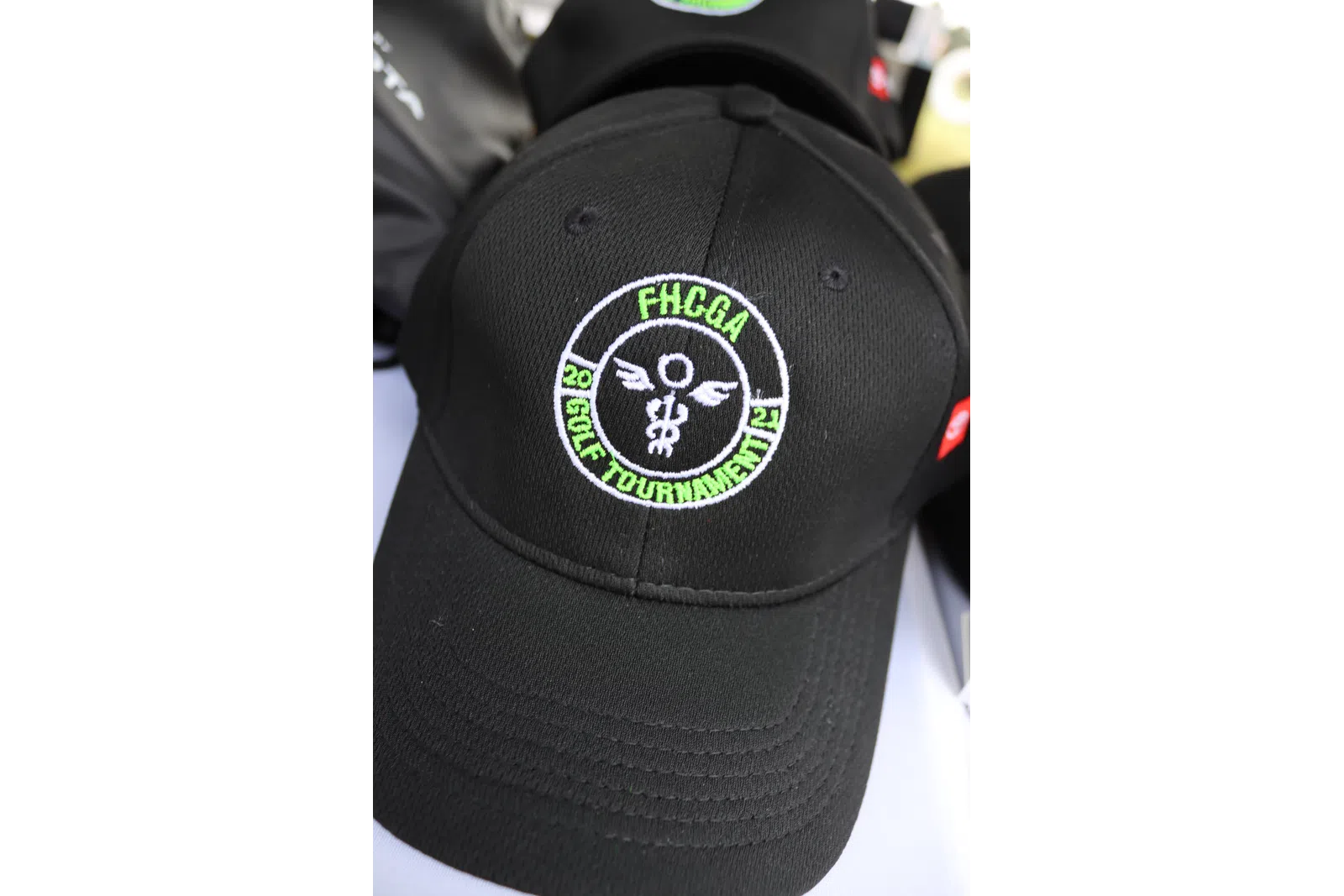 a black hat with a green logo
