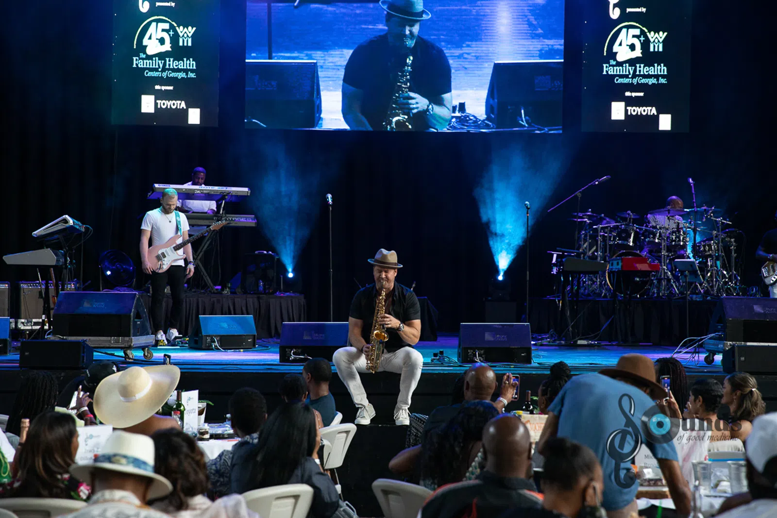 a group of people on a stage in front of a crowd