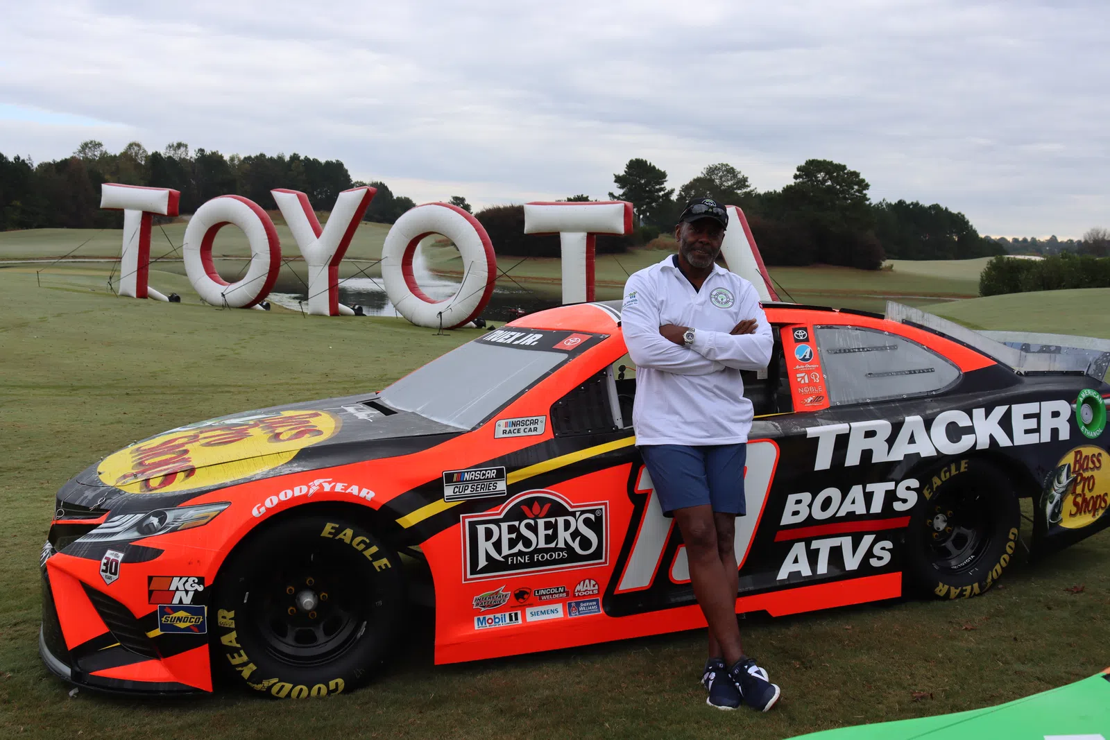 a person standing next to a race car