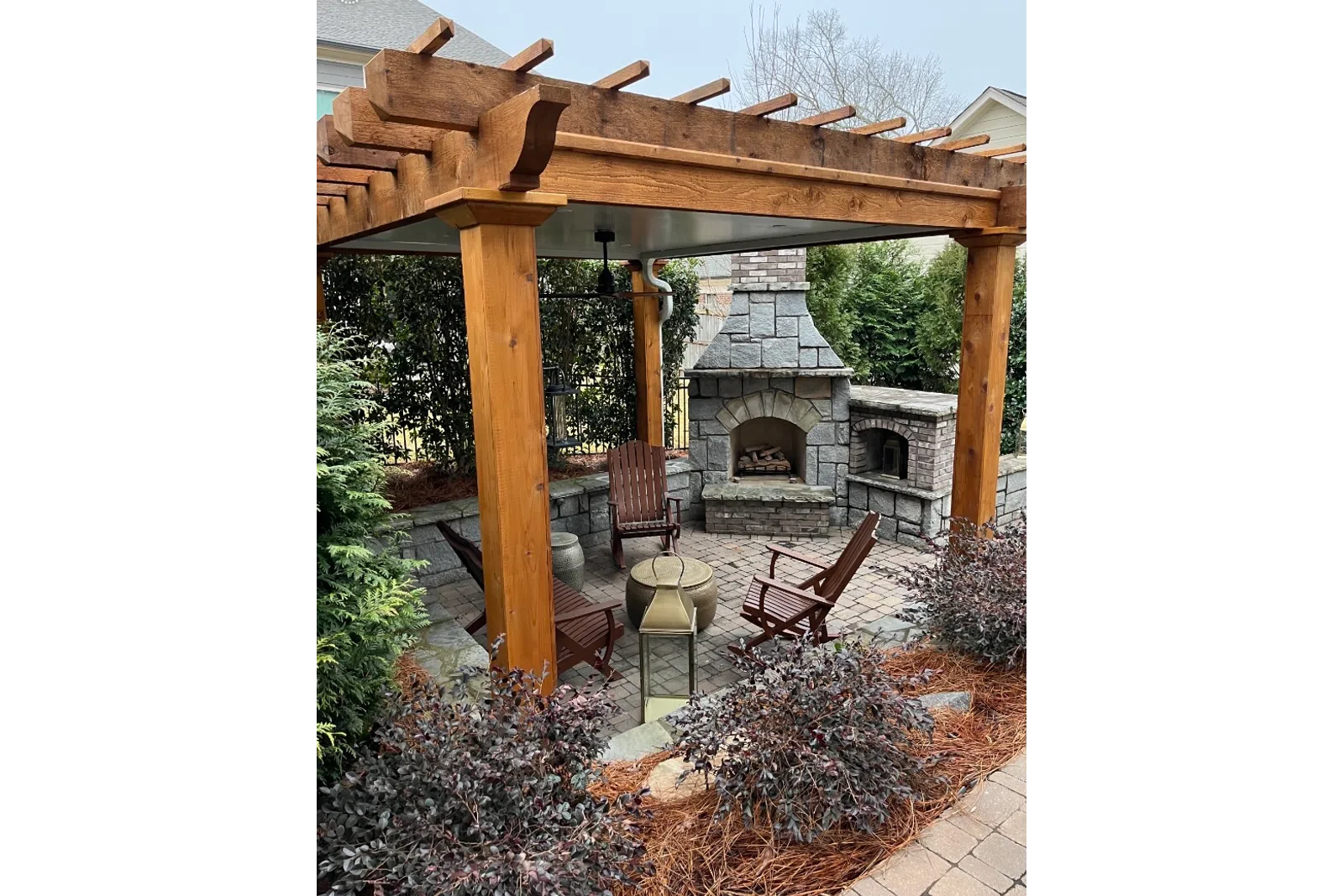a patio with a bench and a fireplace