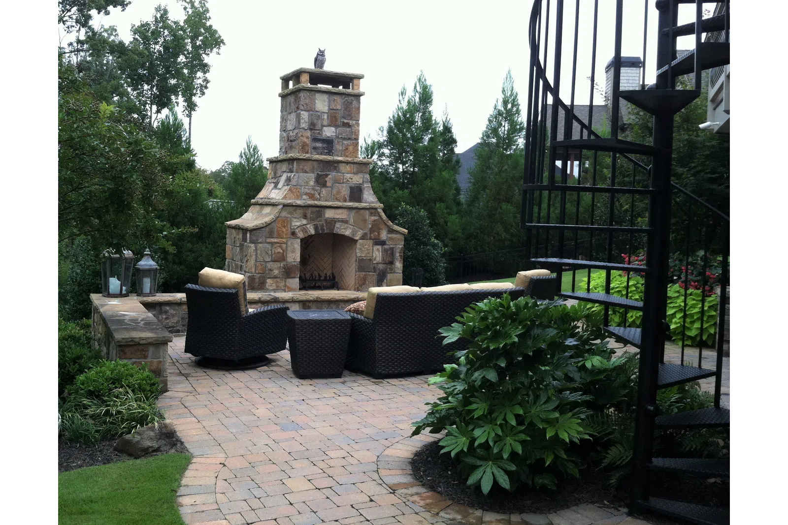 a stone structure with a gate and a stone structure in the background