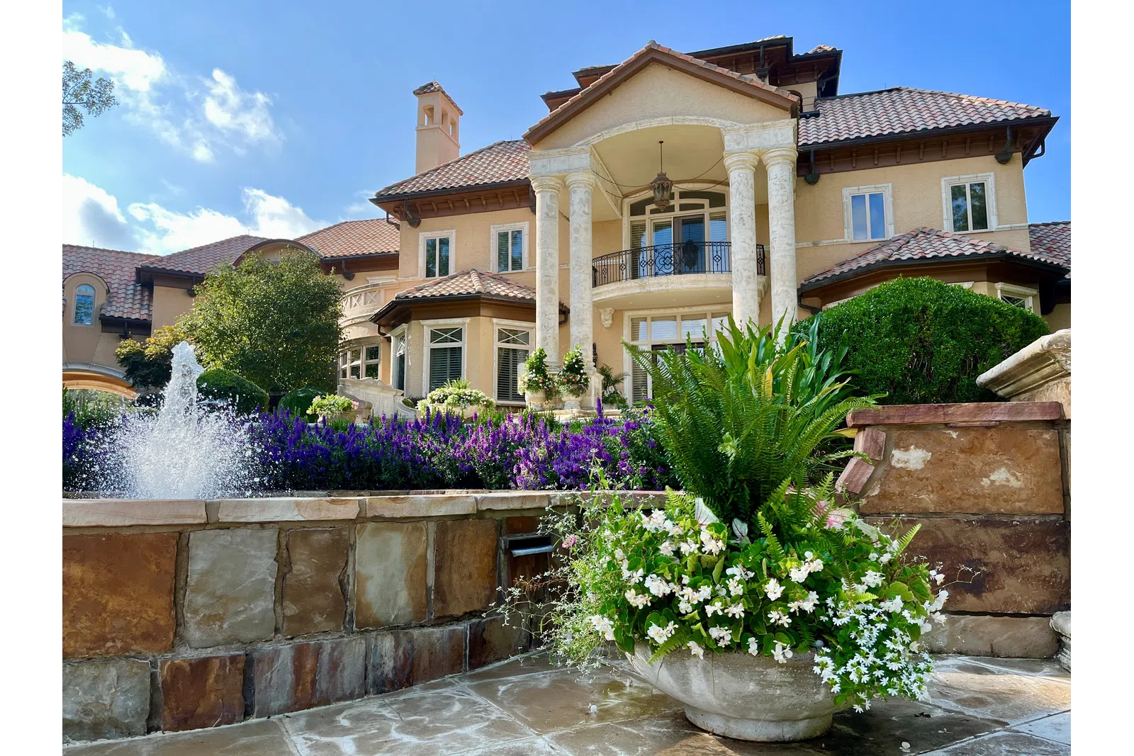 a house with a fountain in the front