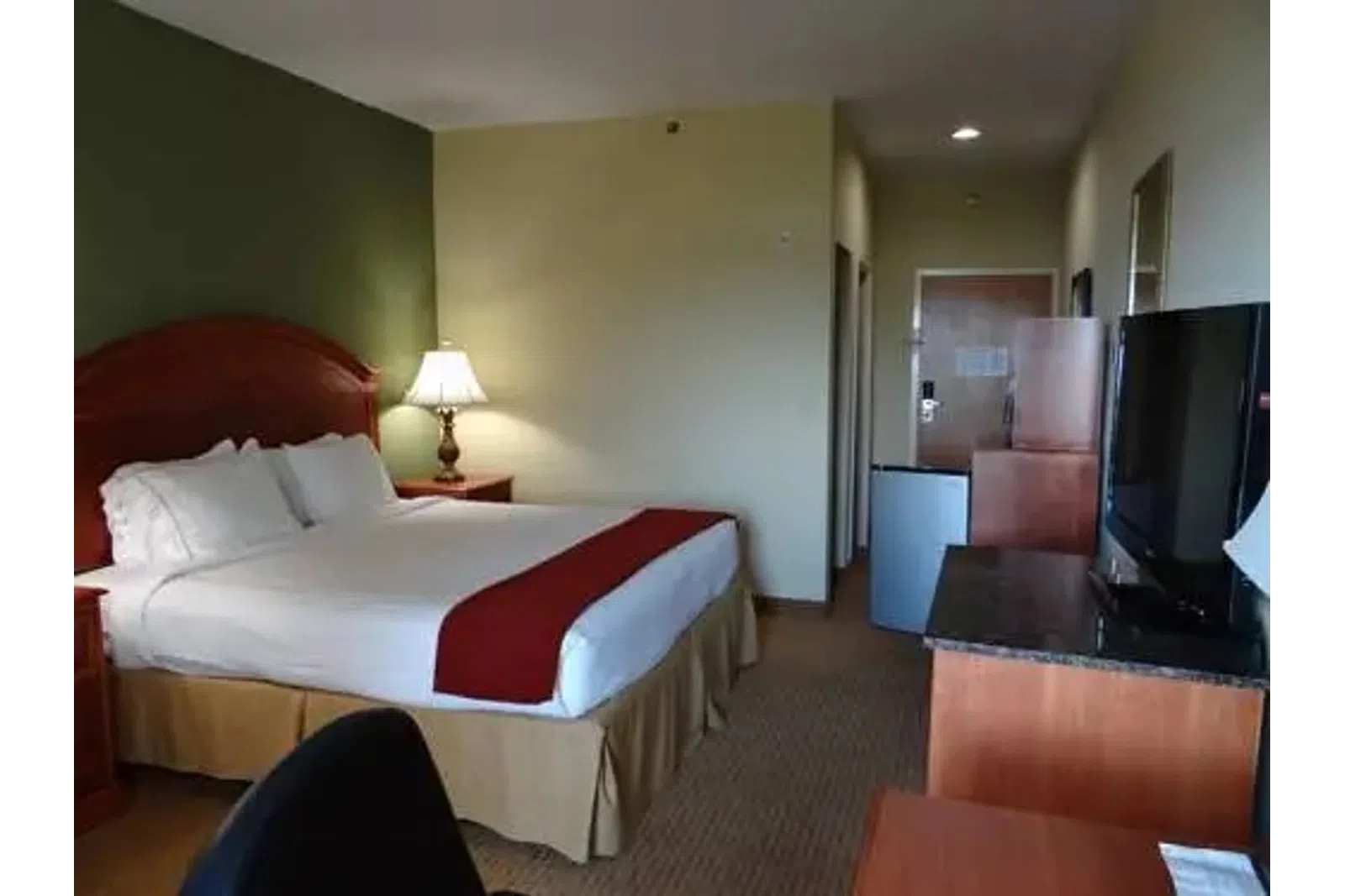 a hotel room with a bed and a tv