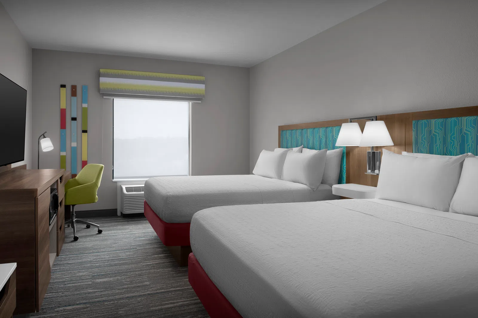 Modern hotel room with two queen beds, white linens, wooden furniture, green chair, and a large window with blind.