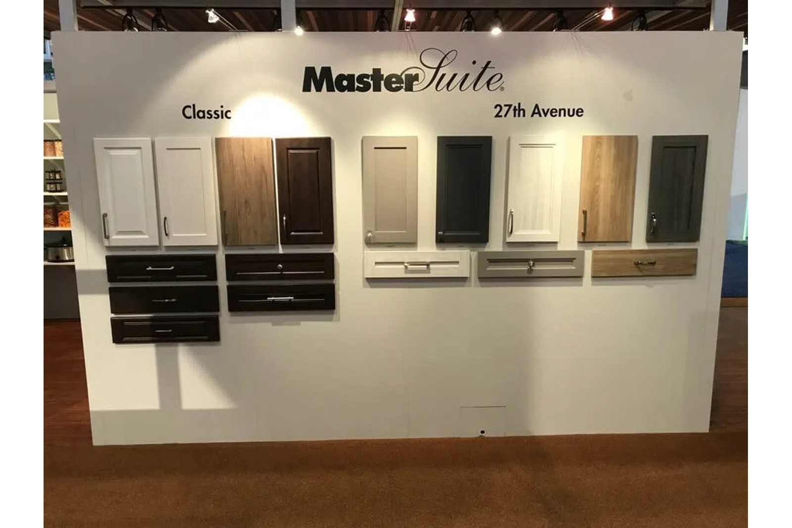 Display of MasterSuite cabinetry and drawer front styles in Classic and 27th Avenue collections on white board.