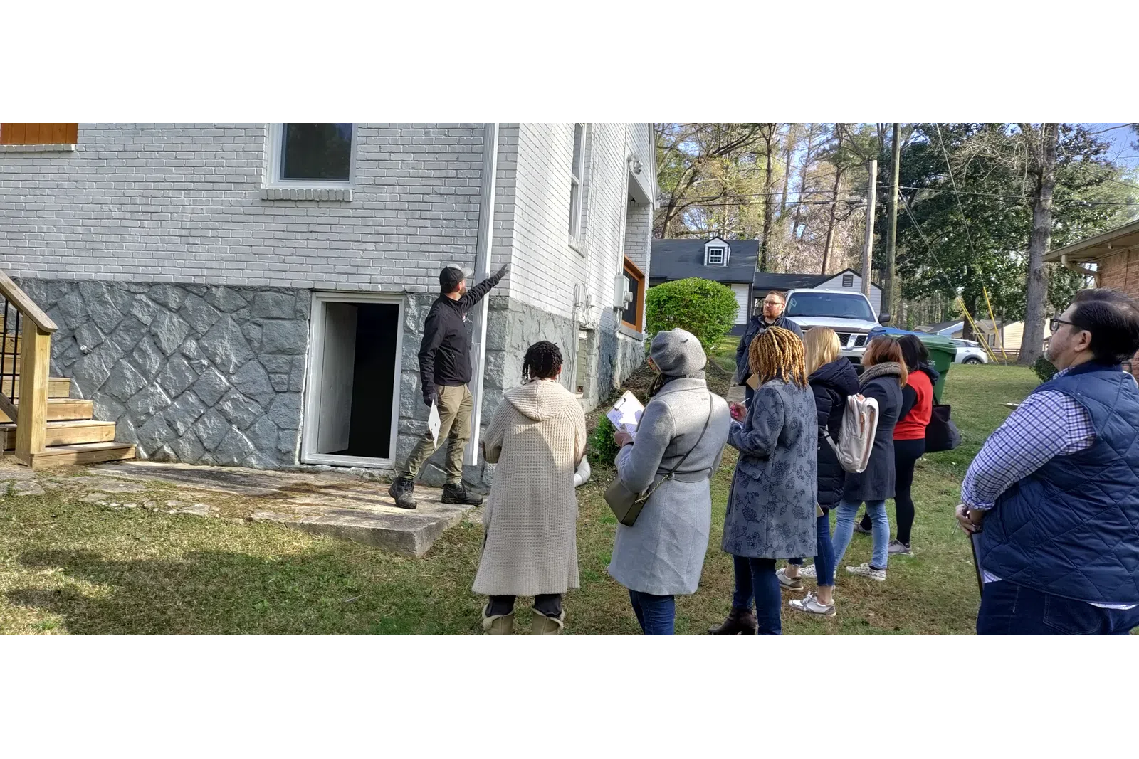 a group of people standing outside a house