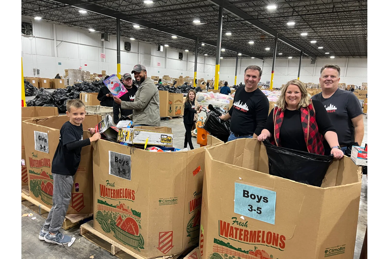 a group of people standing next to boxes