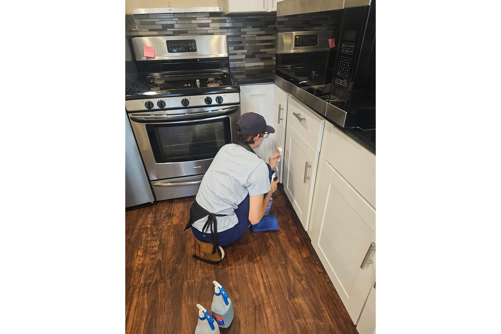 MaidPro Chicago Downtown, West and South cleaning professional scrubbing kitchen cabinets