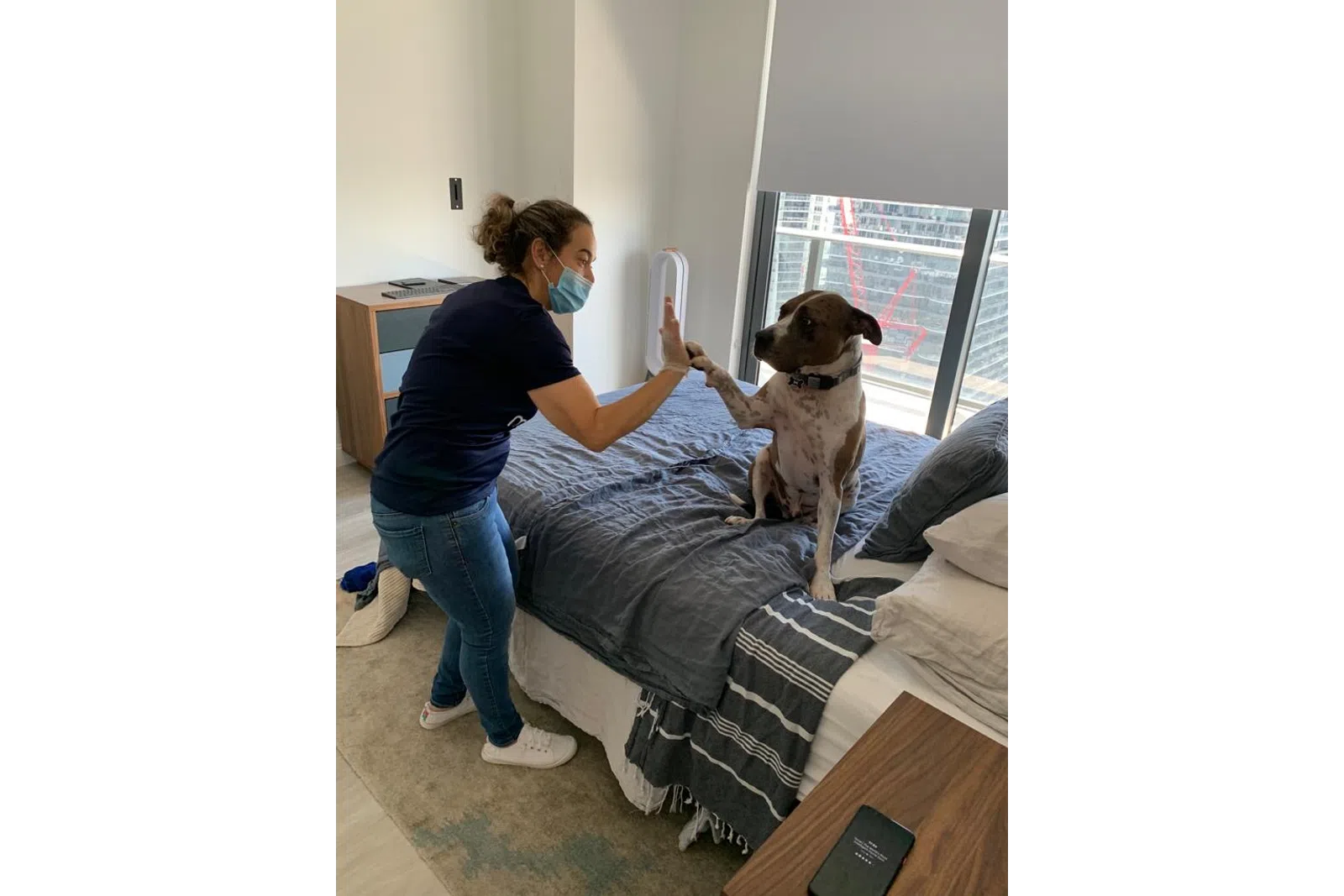 a woman playing video games with a dog