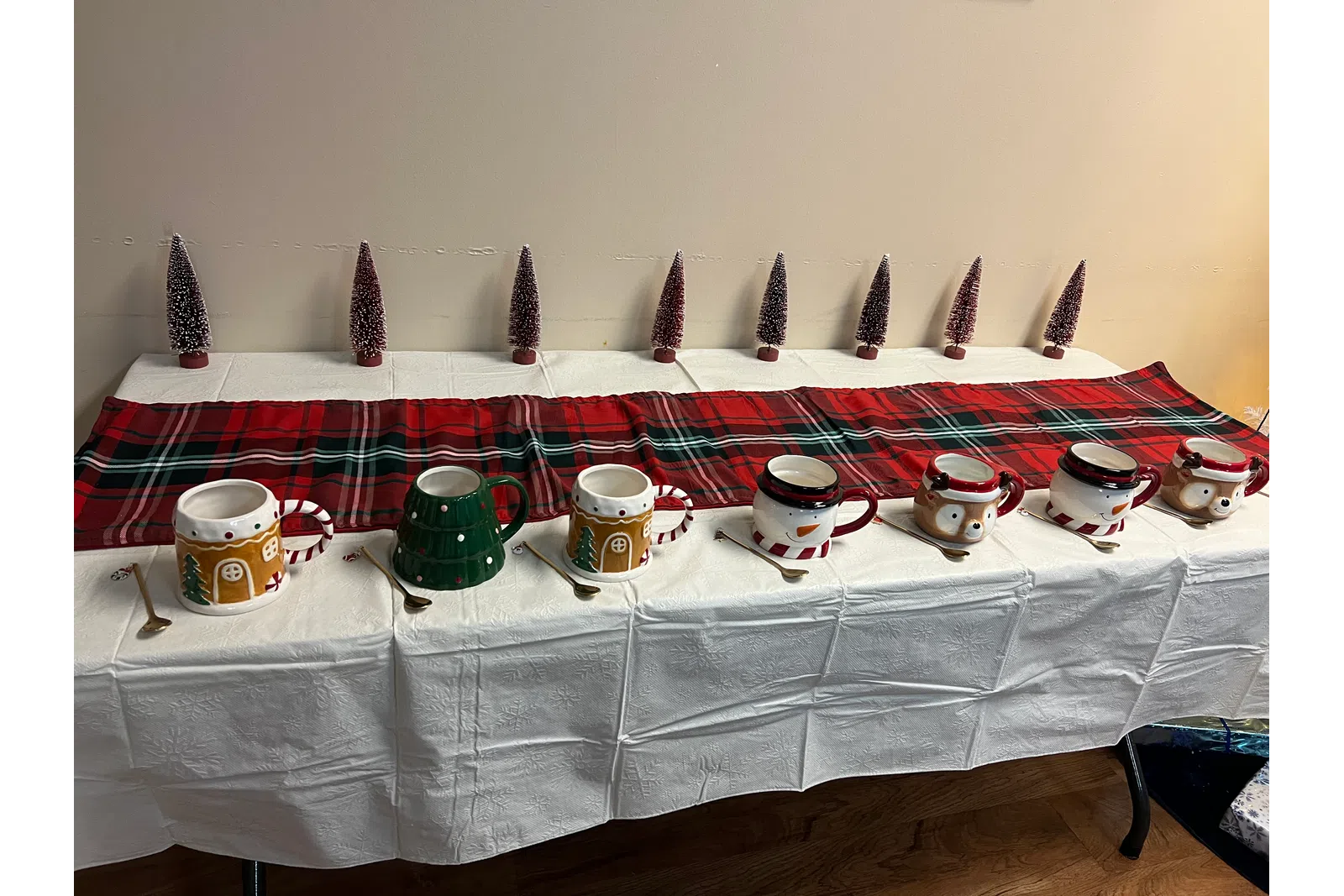 a table with a white tablecloth and a white tablecloth with coffee cups and a white table