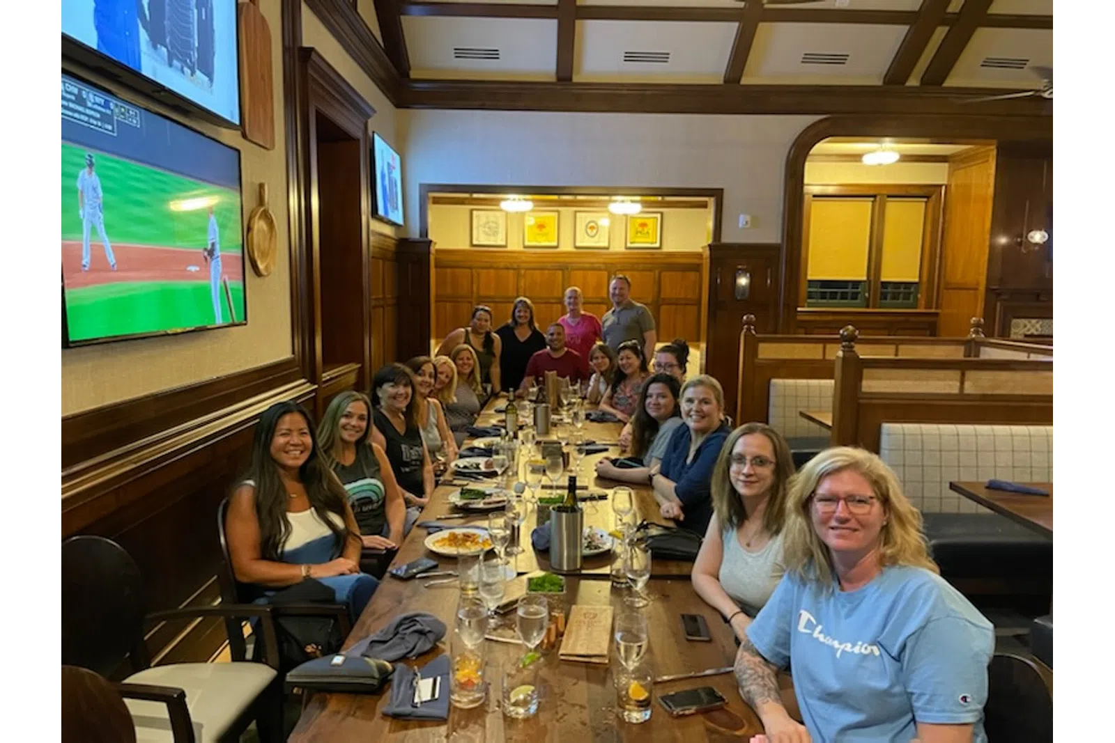 a group of people sitting at a table in a restaurant