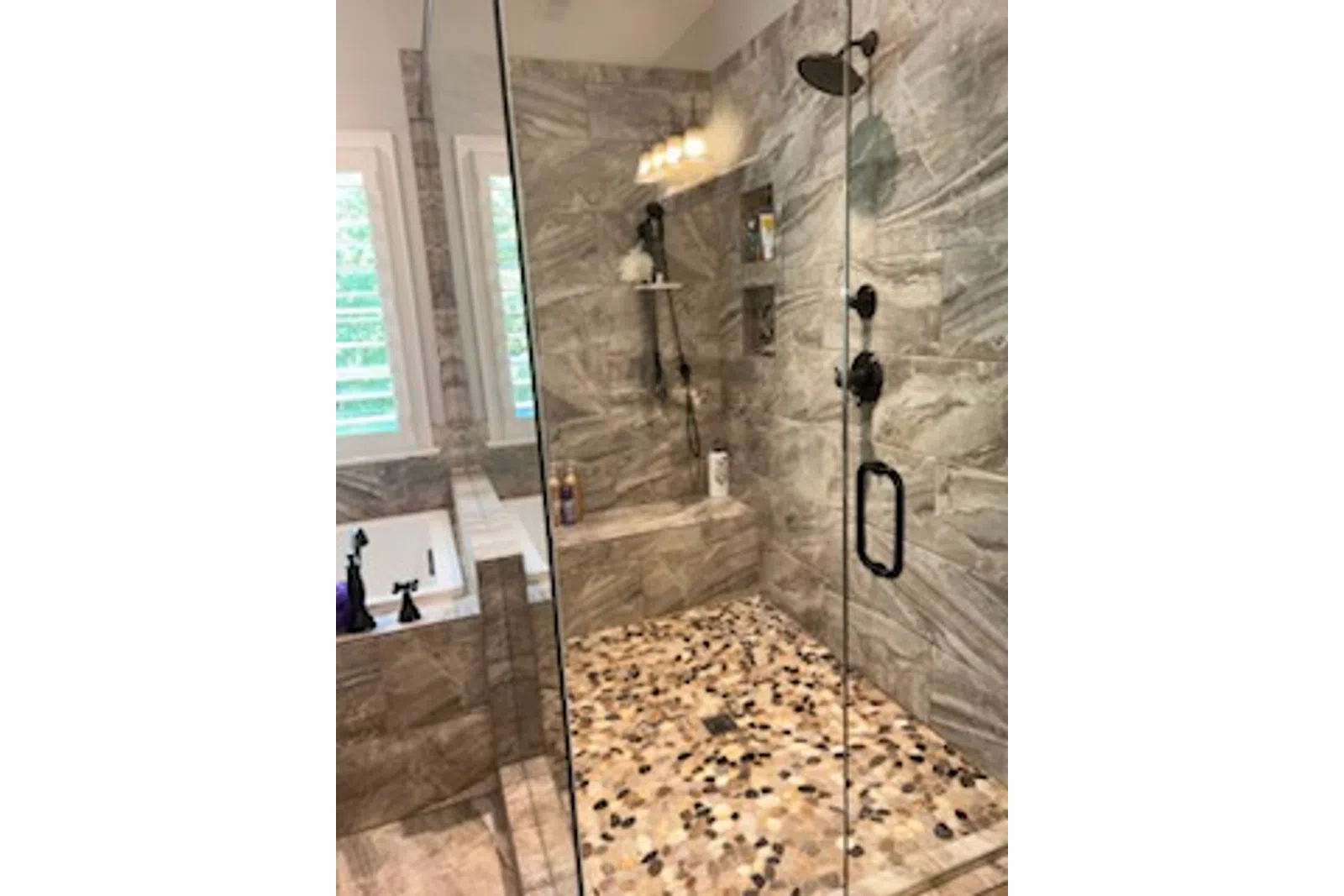 a shower with a glass door cleaned by the experts, MaidPro 