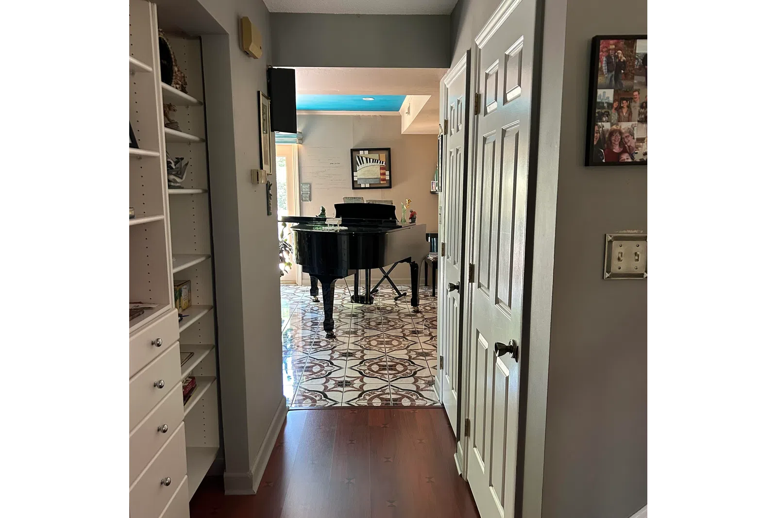 a room with a desk and shelves