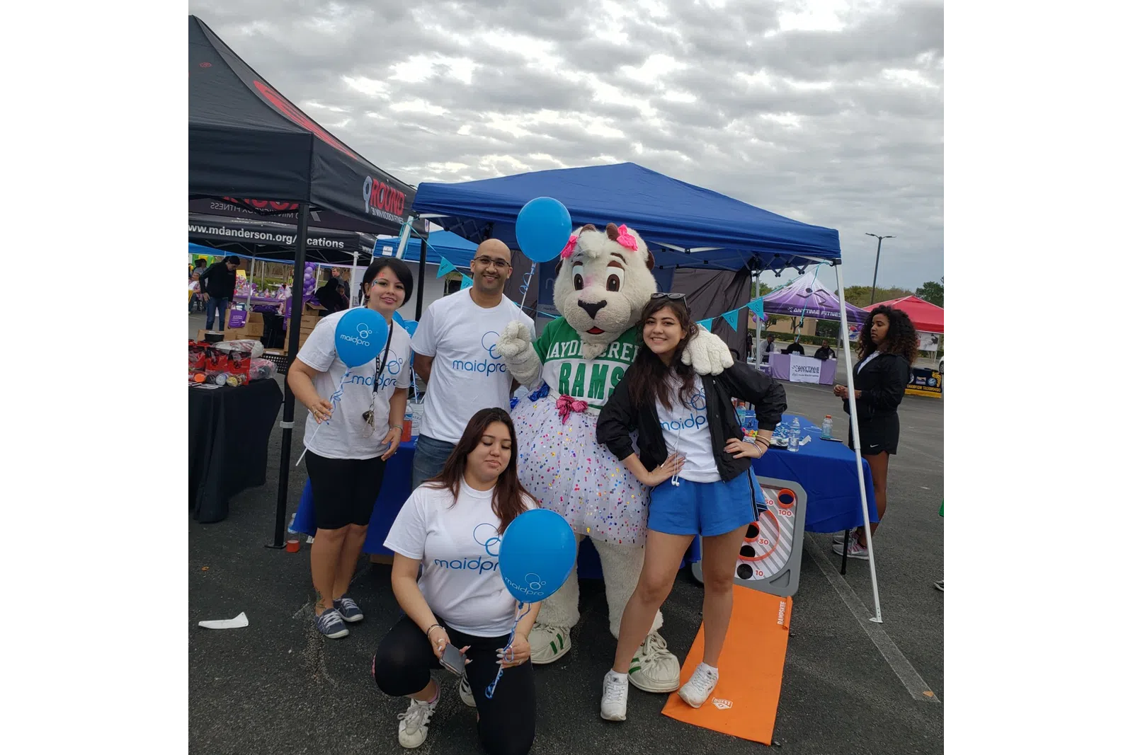 MaidPro Katy house cleaning professionals posing for photos at a local event
