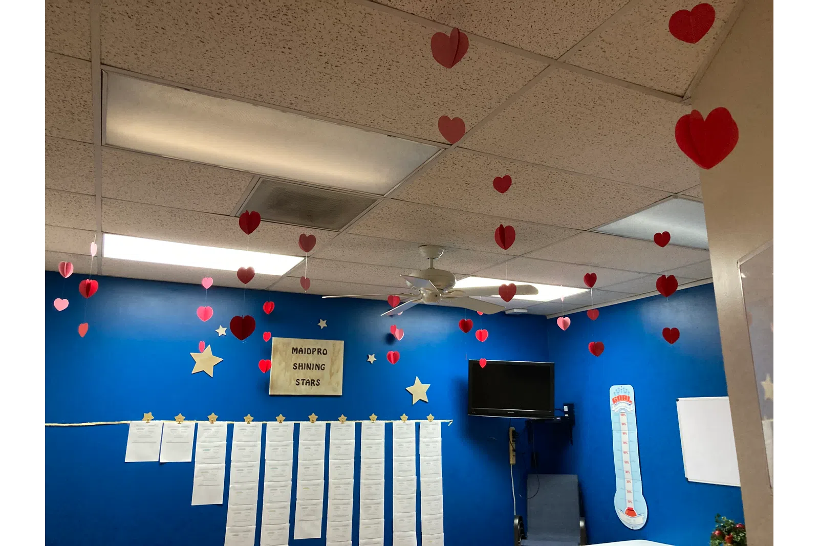 a room with a television and balloons