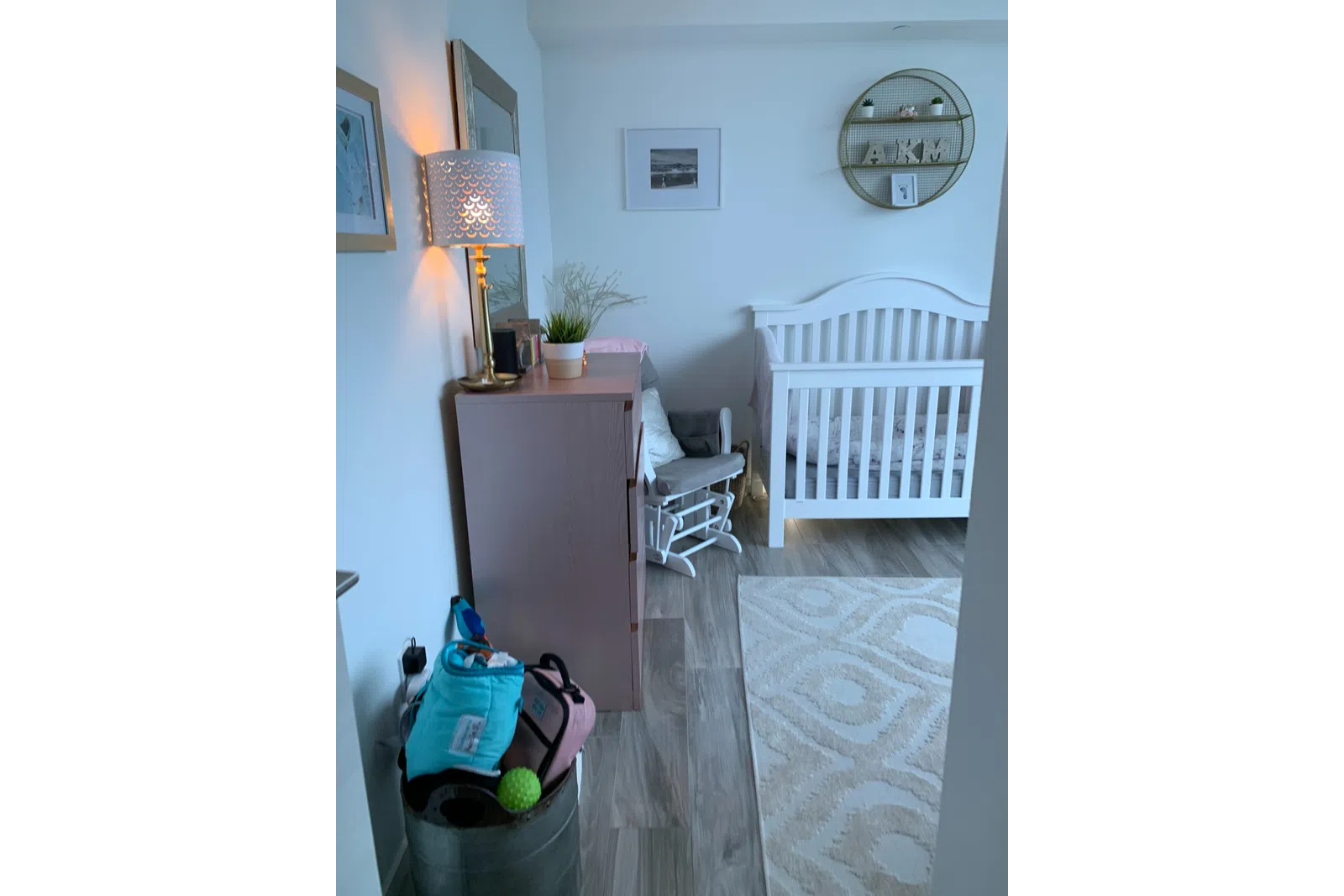 a room with a bed and a desk with a computer and a clock