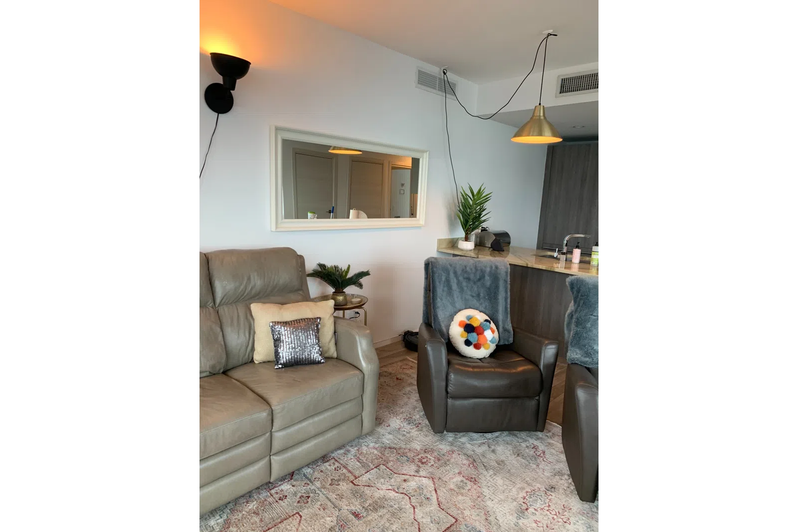 a living room with a couch and a mirror